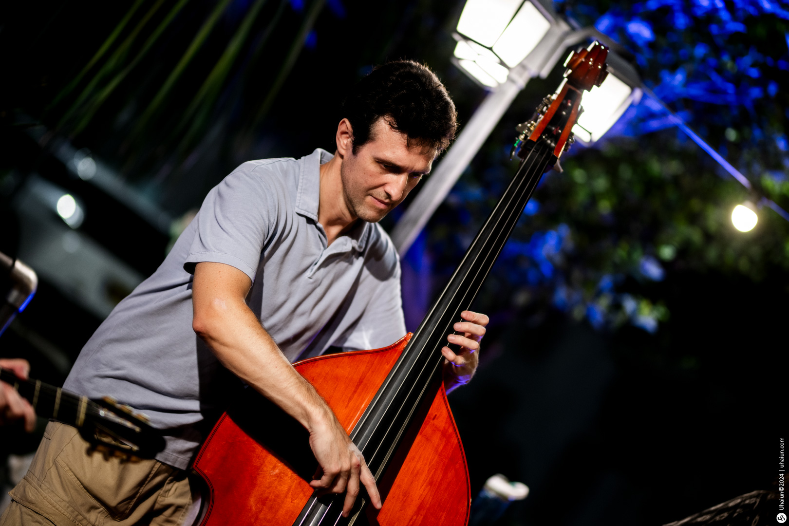 Man playing double bass at an evening event