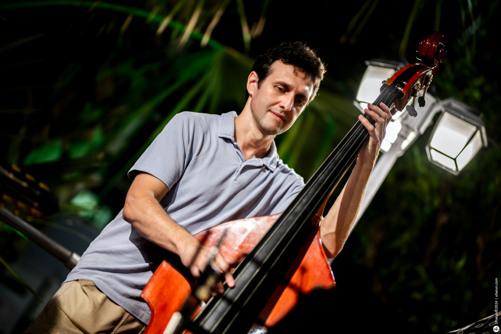 Man playing double bass at a night event