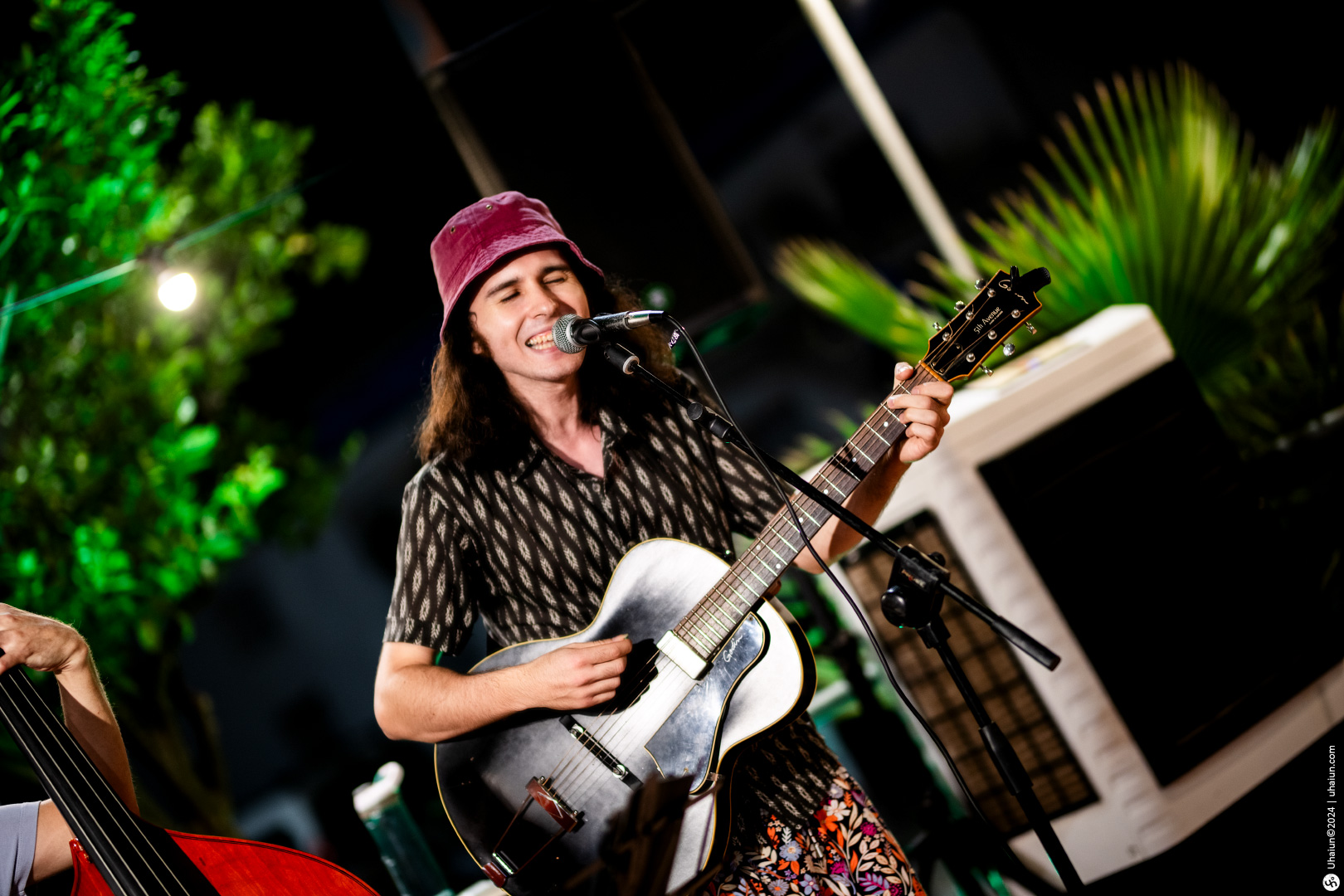 Guitarist performing live music on stage outdoors