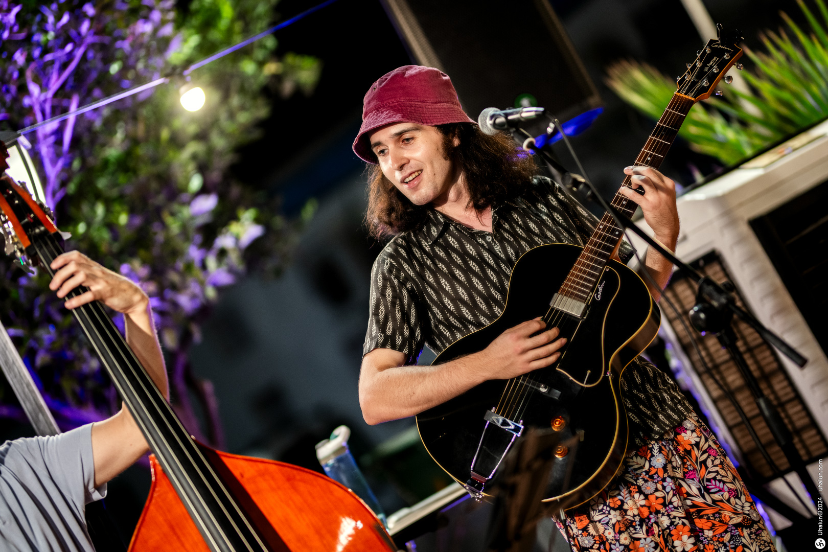 Musician playing guitar at night event