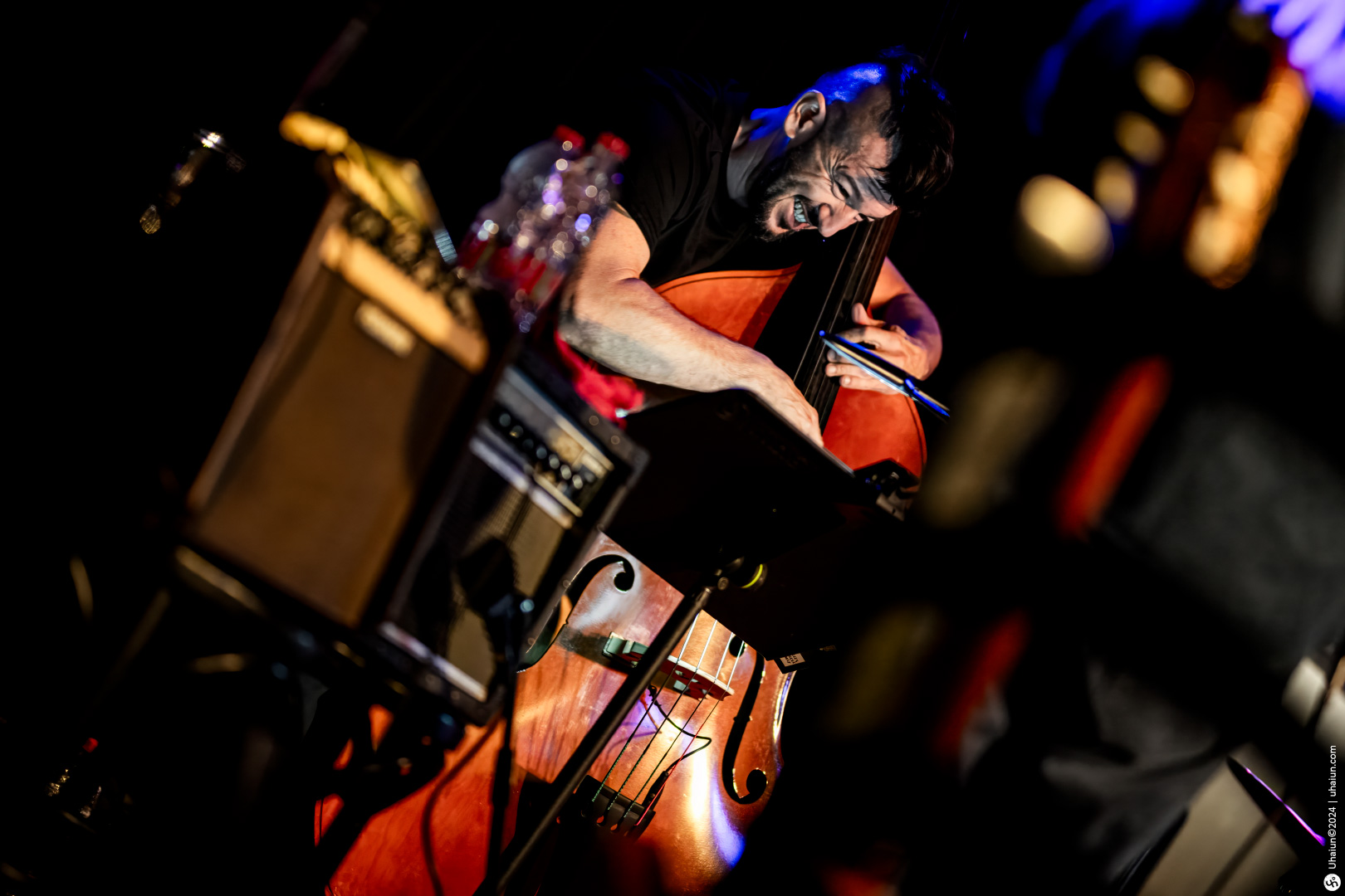 Musician playing double bass on stage concert