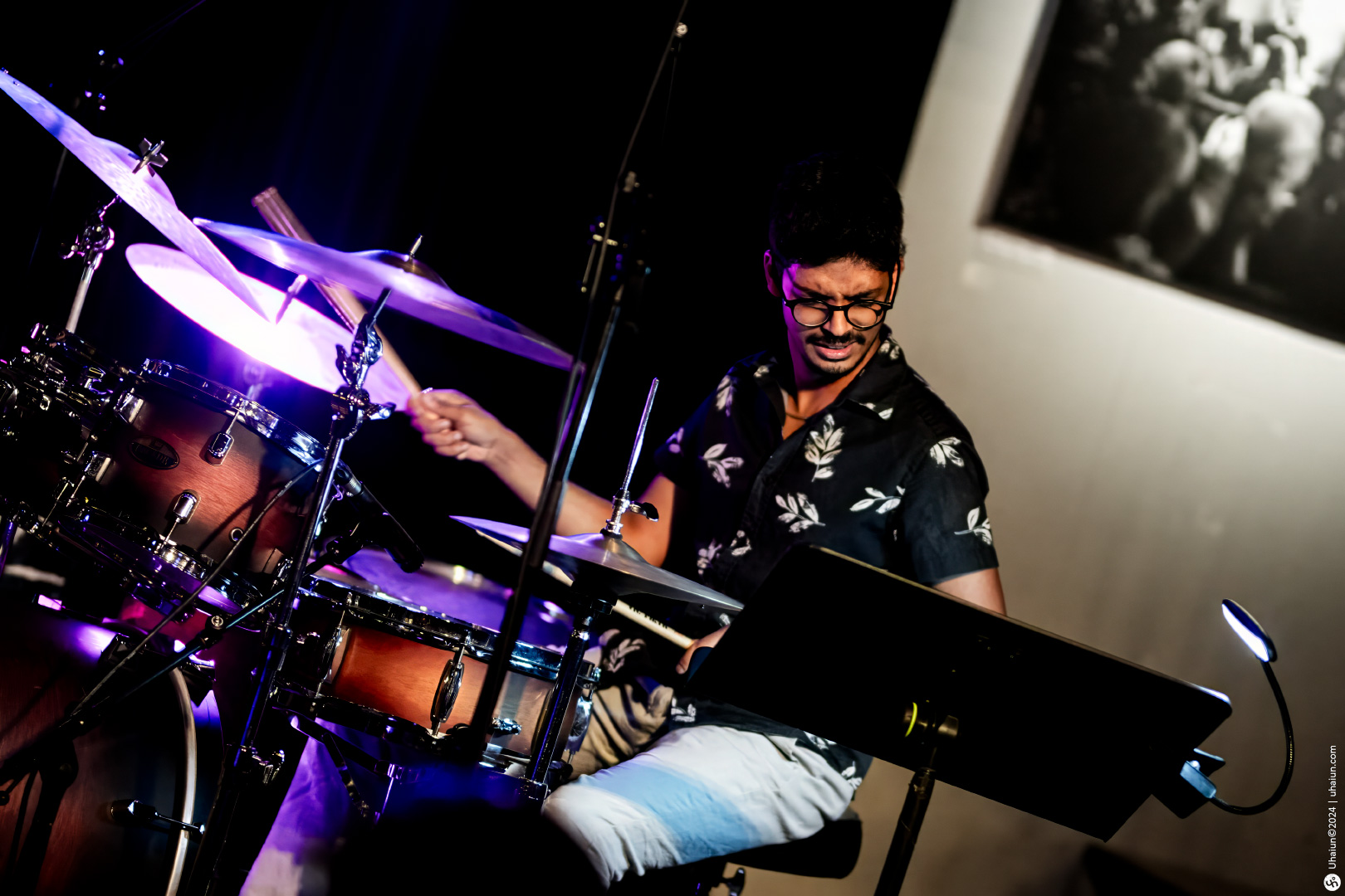 Drummer enjoying performance under stage lights