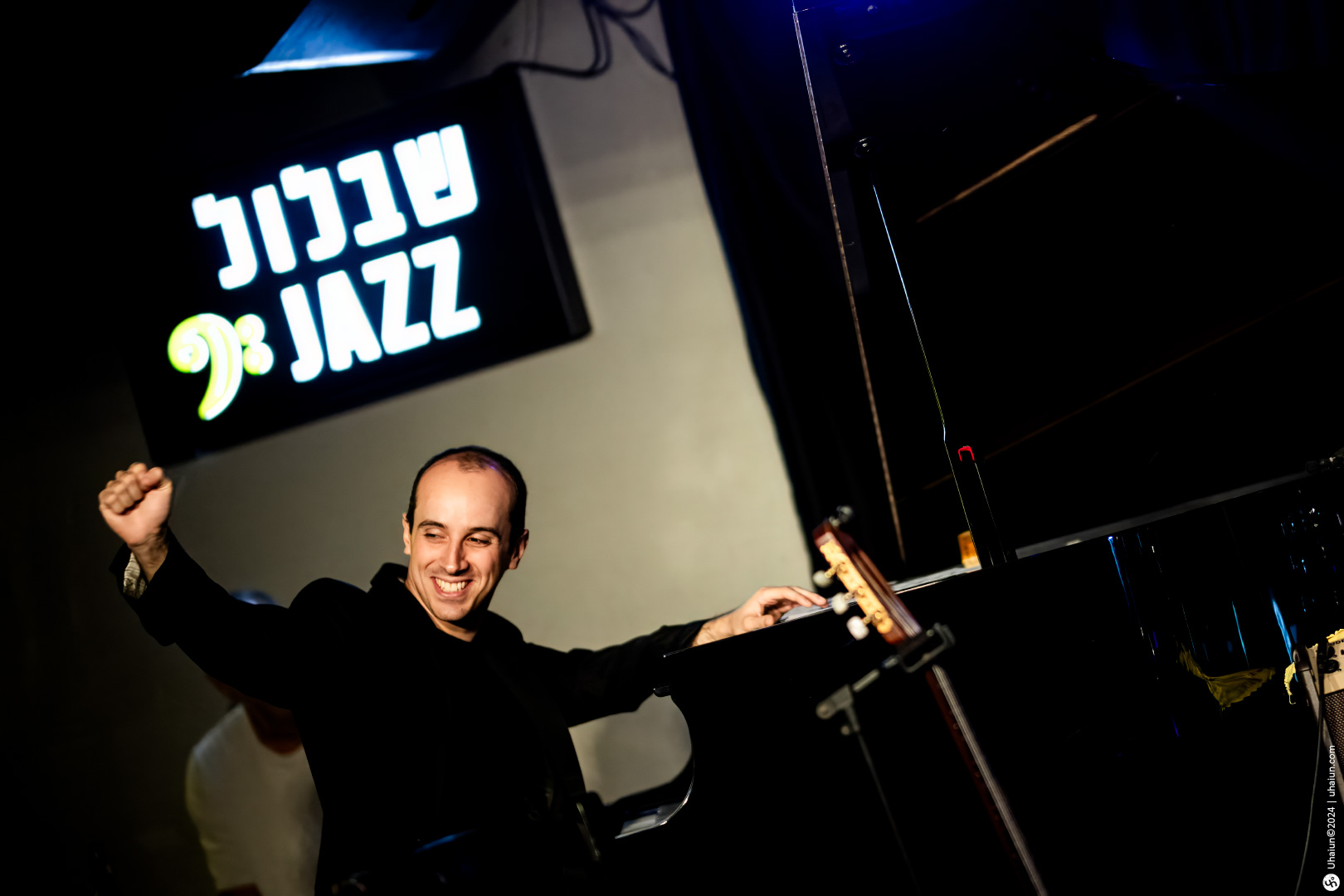 Man smiling at a jazz club performance