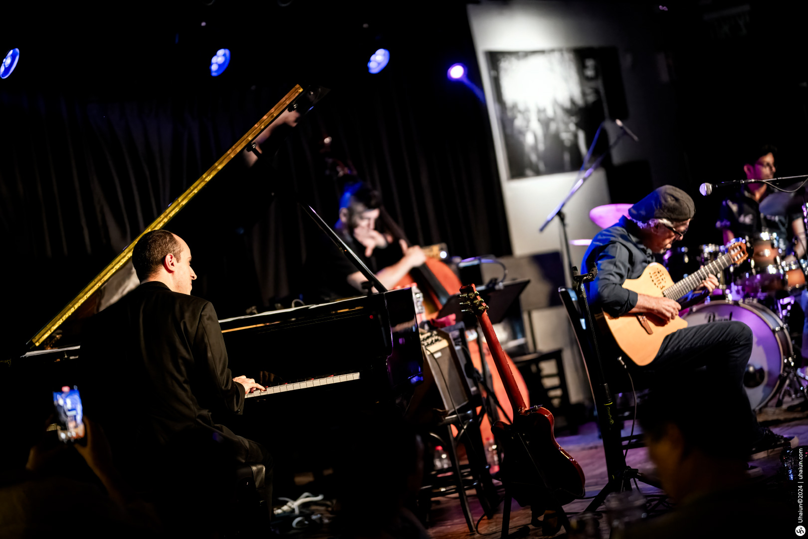 Live jazz band performing on stage with piano