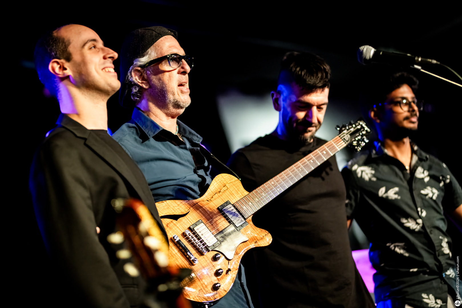Mordy Ferber playing guitar with band on stage