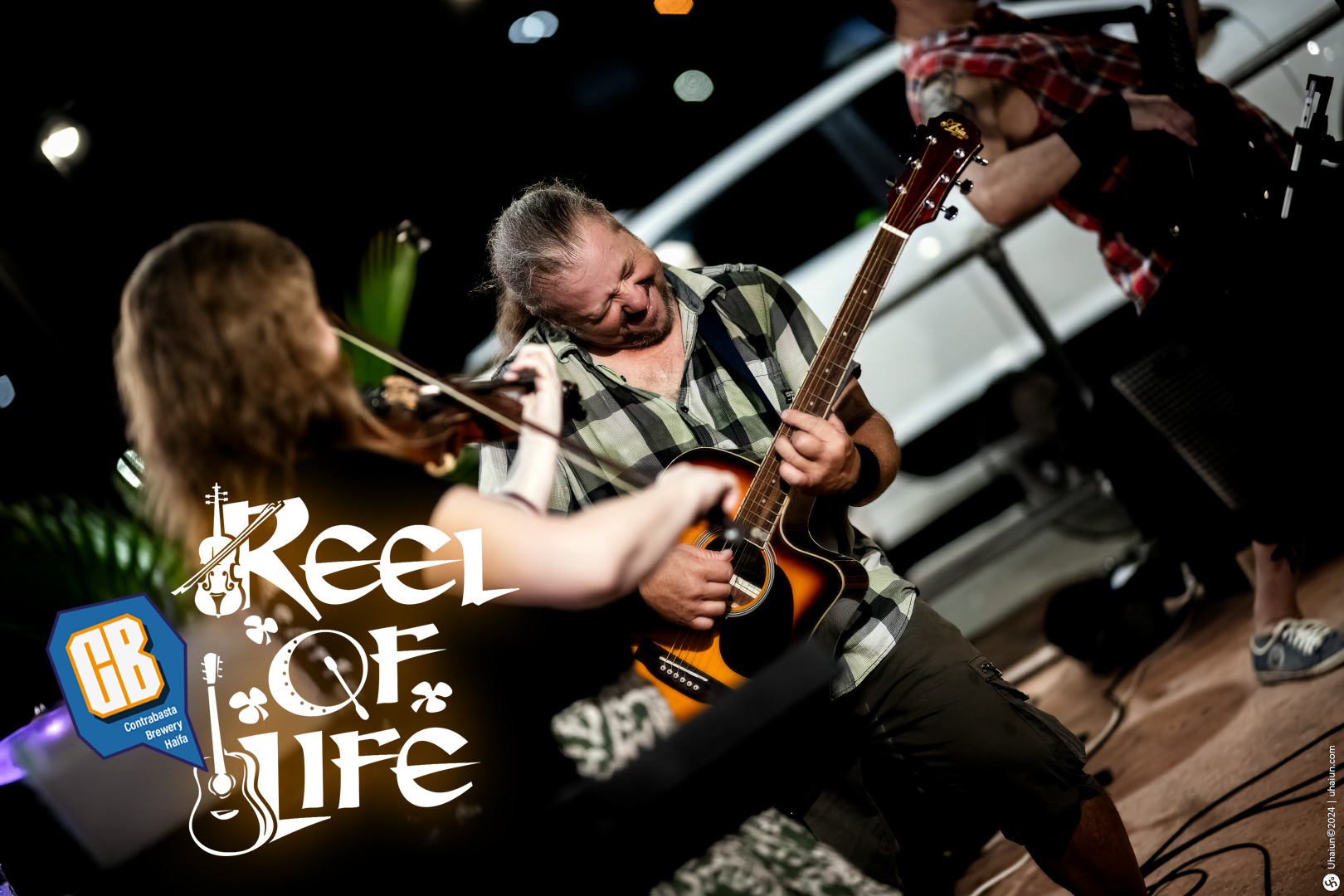 Reel of Life band members performing live on stage.