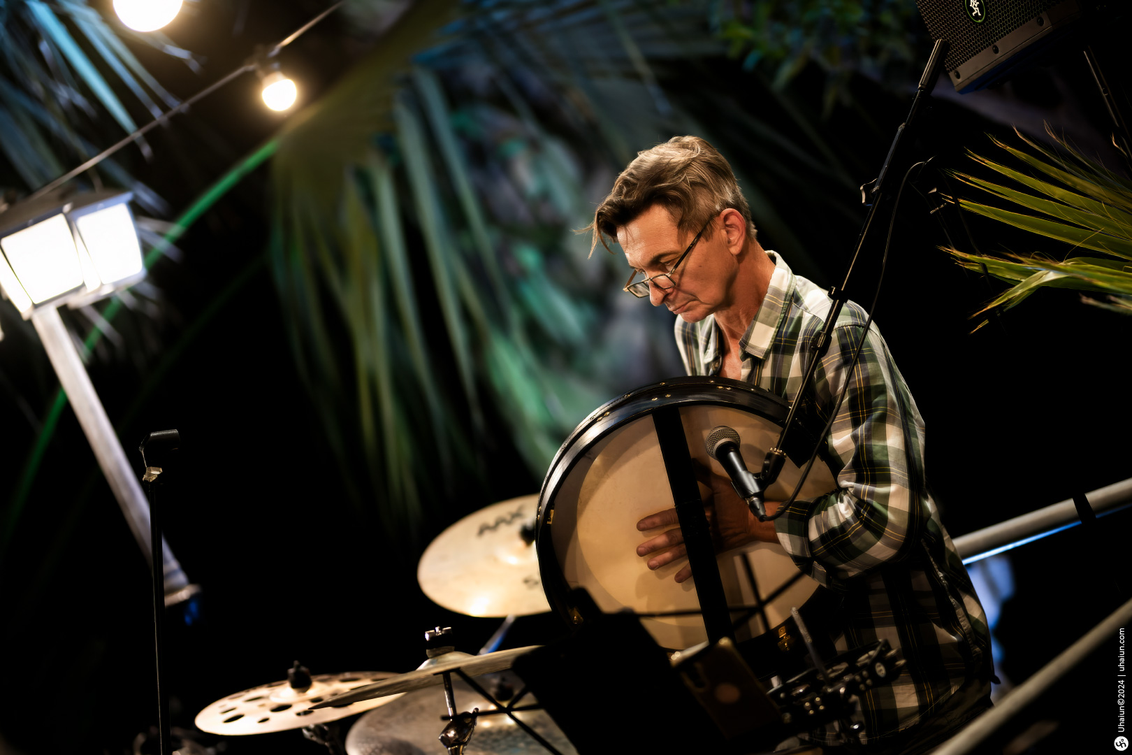Man tuning percussion instrument on stage