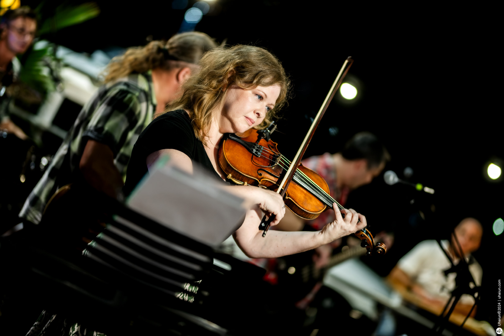 Woman playing violin in live performance