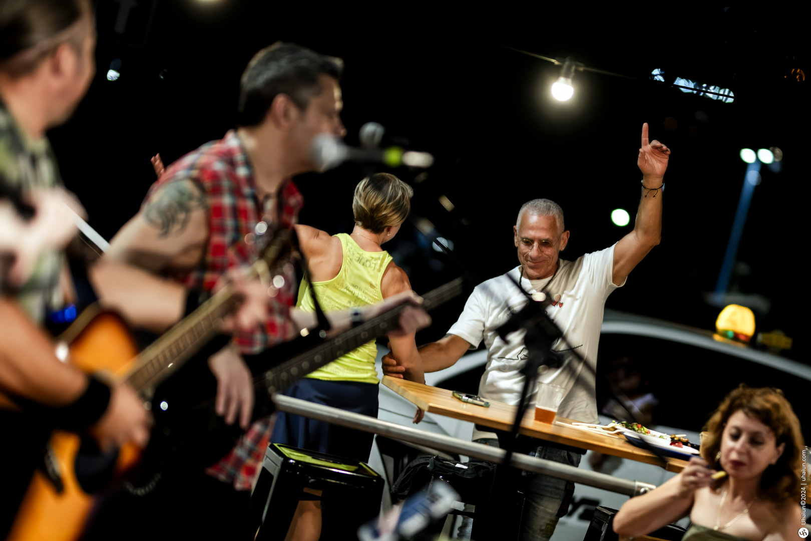 Man raising hand during live music performance