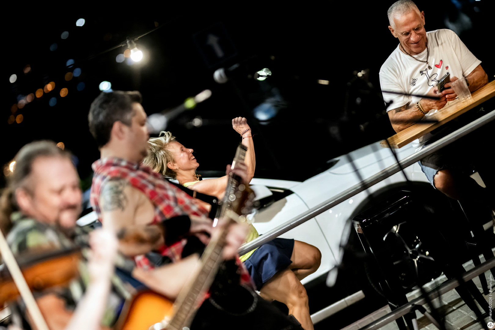 Musicians performing live with enthusiastic audience watching