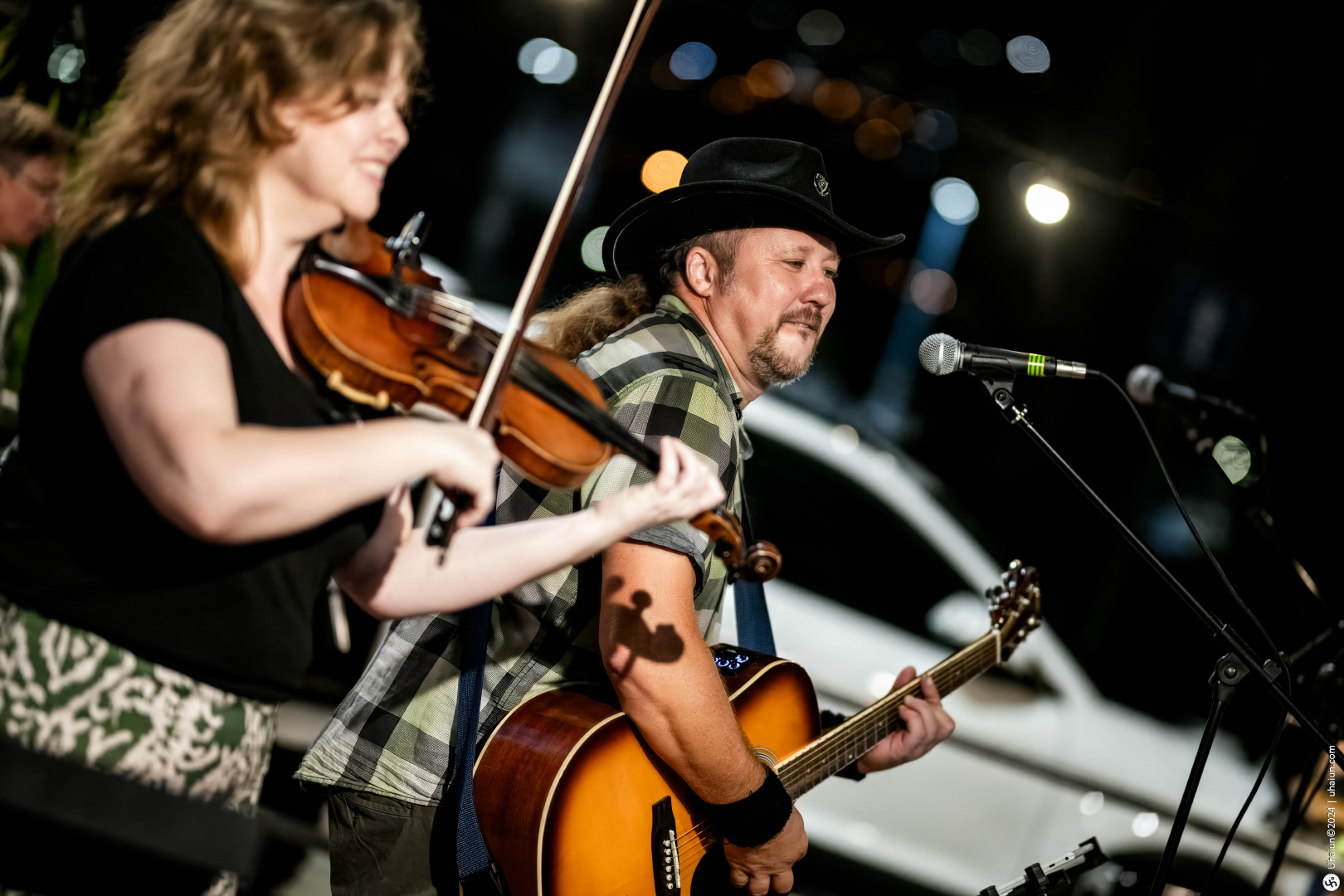 Violinist and guitarist performing live on stage