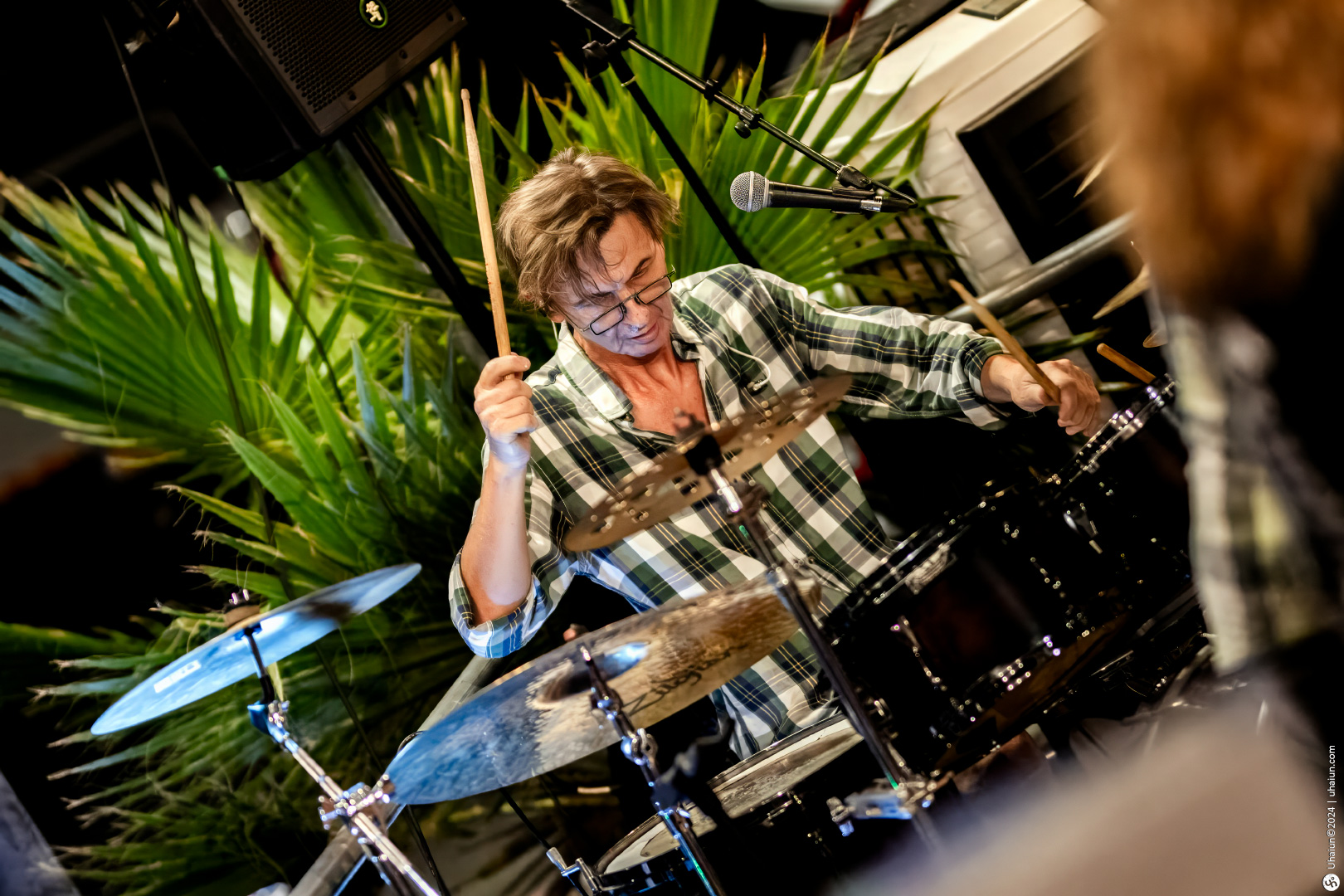 Passionate drummer playing in a live session