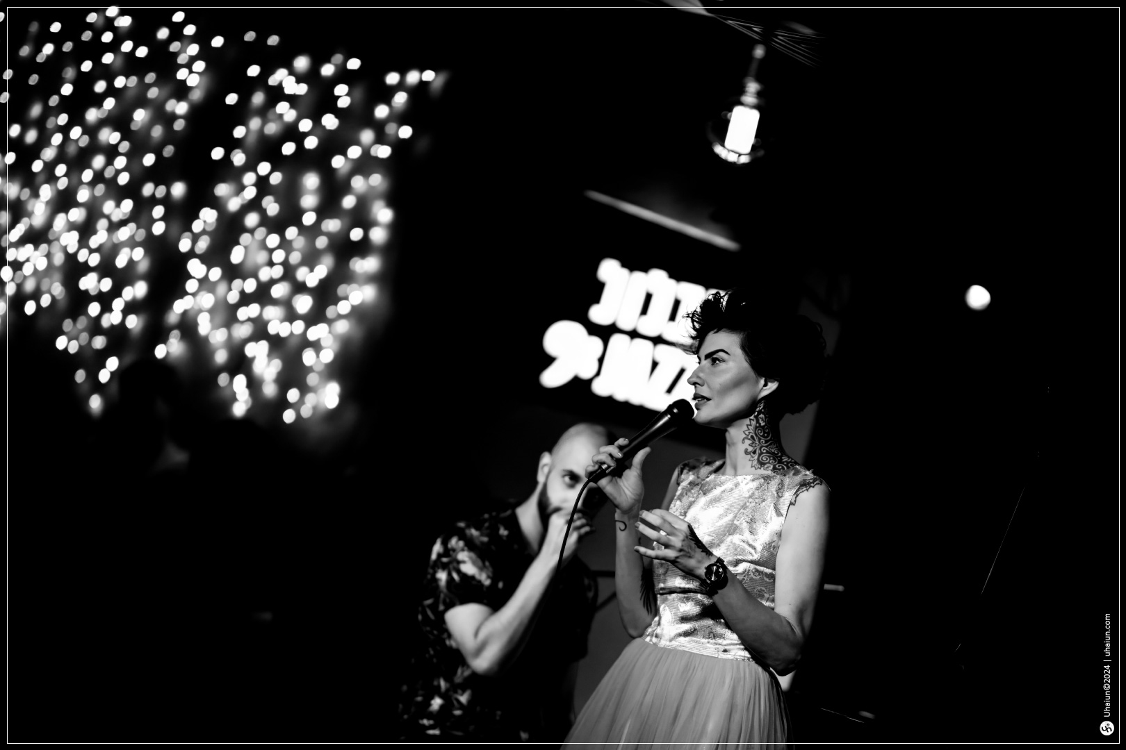 Kama Kamila performing on stage in black and white