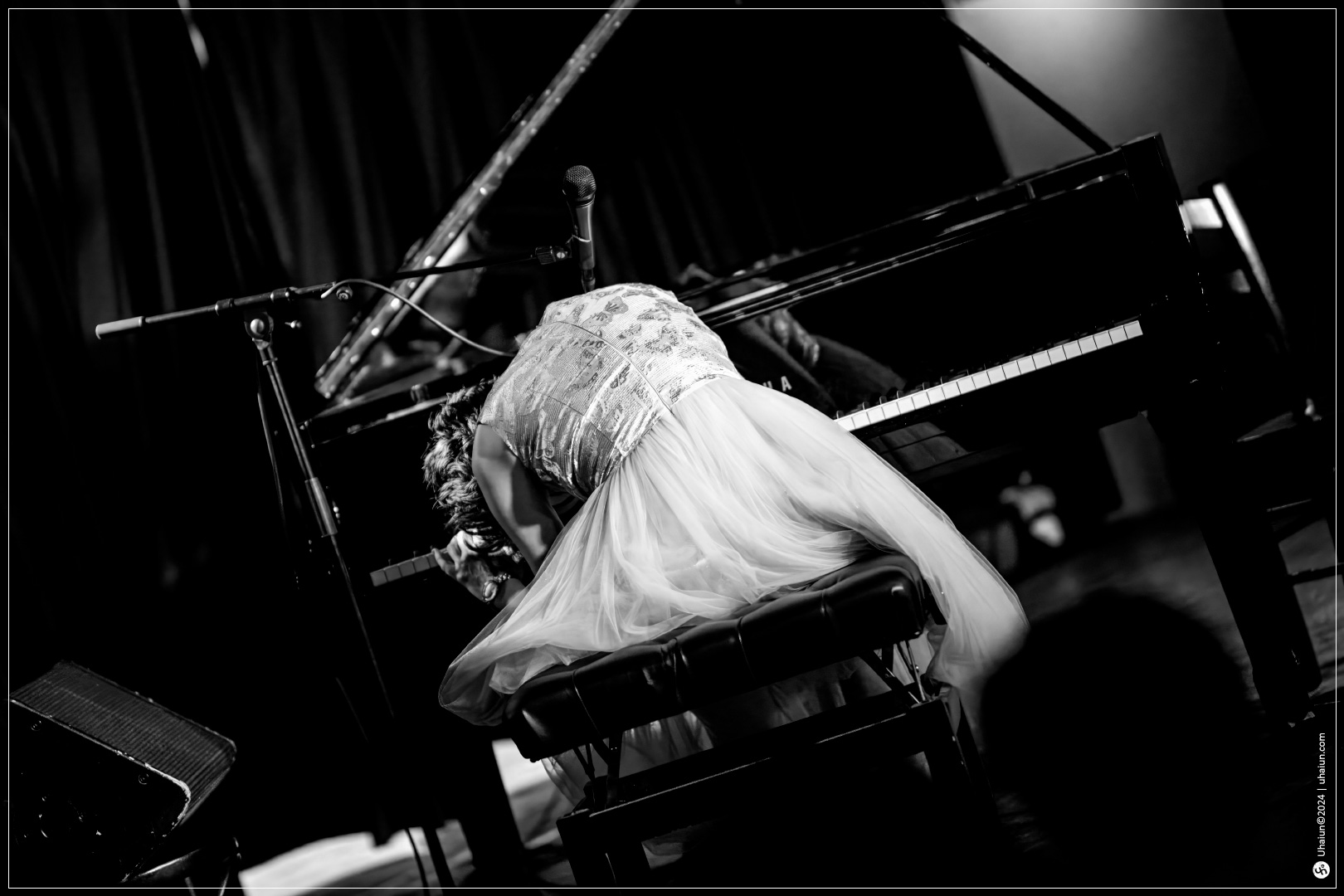 Kama Kamila playing piano on stage in concert