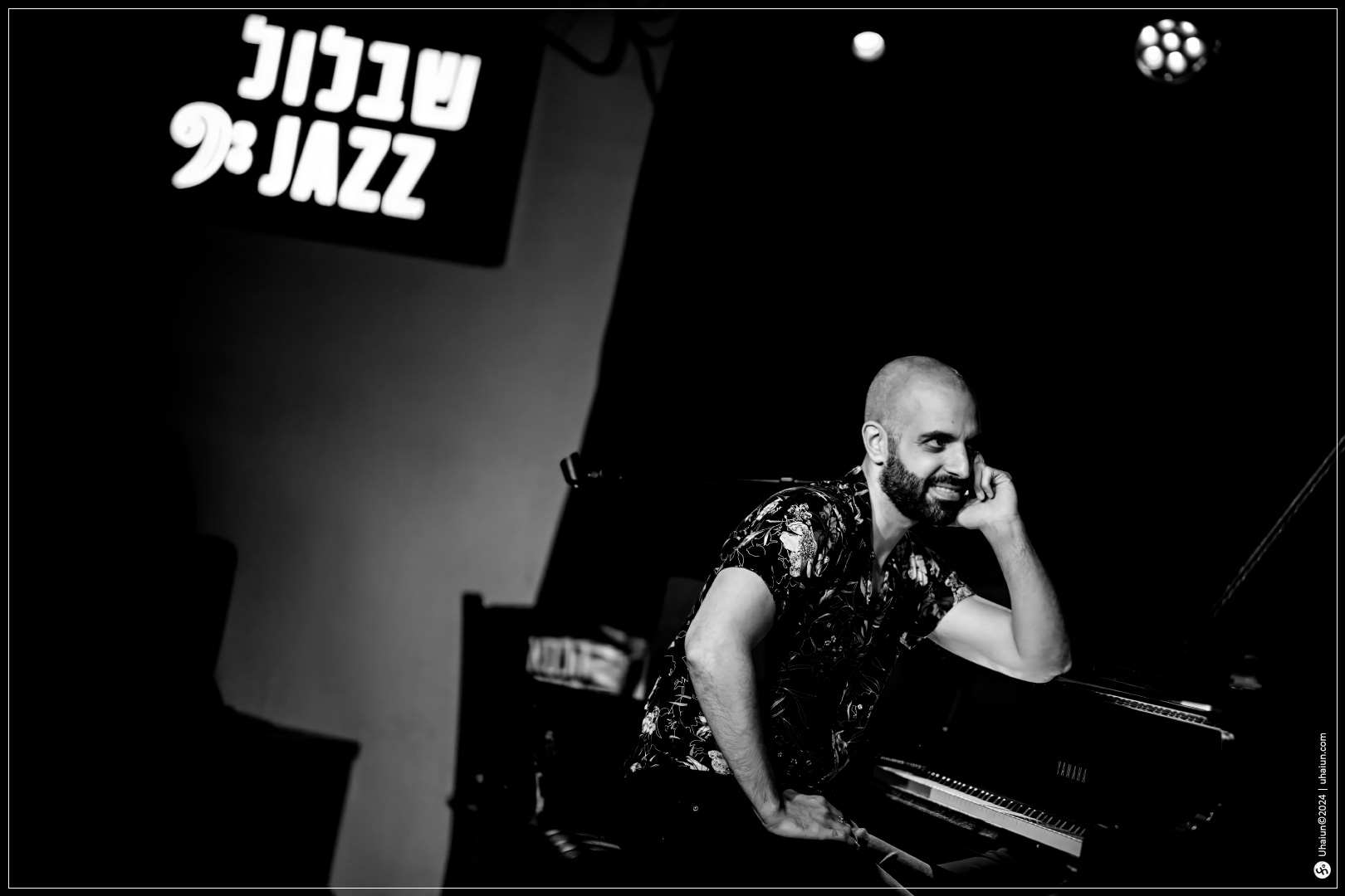 Pianist smiling at jazz club concert stage