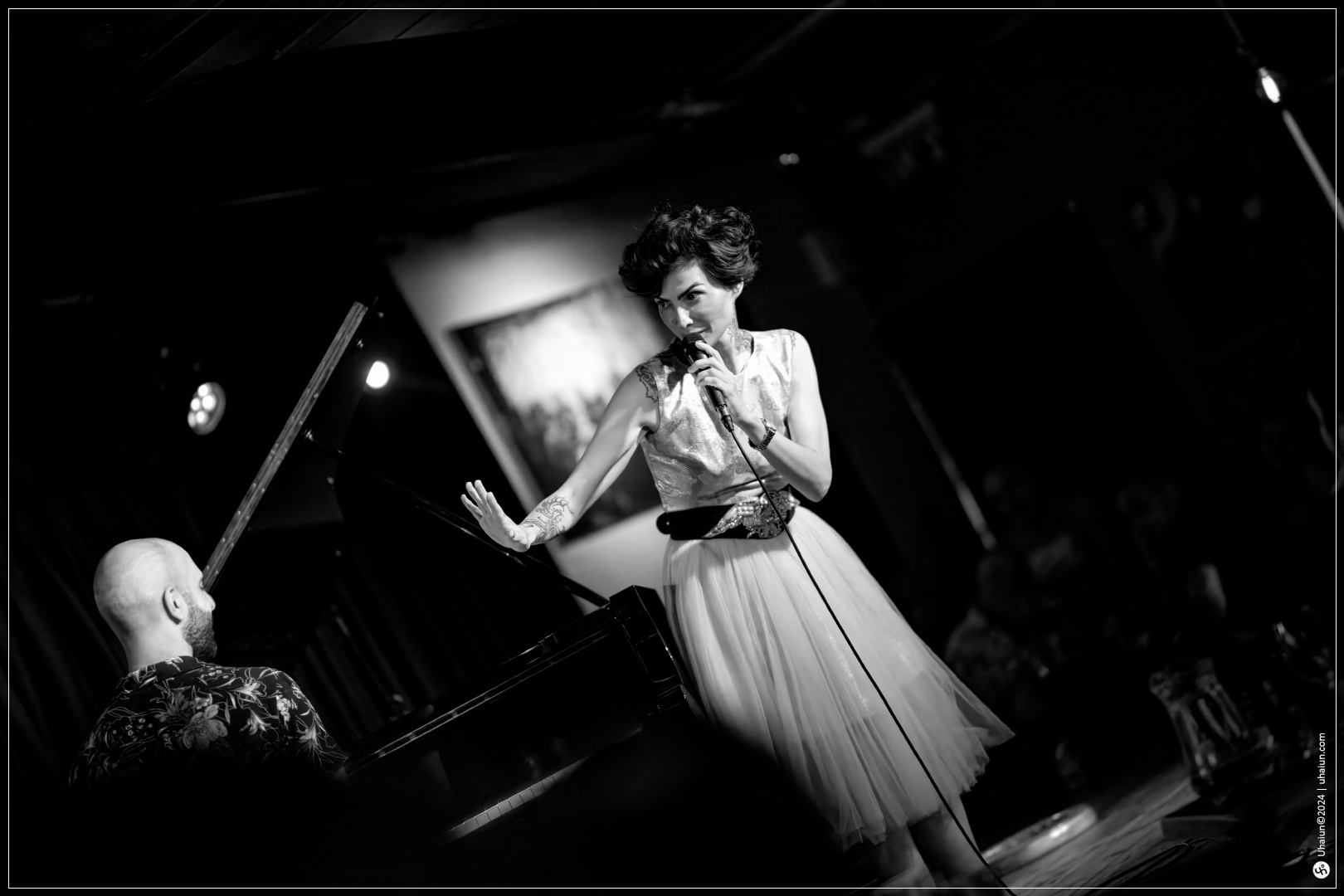 Kama Kamila performing live on stage with pianist