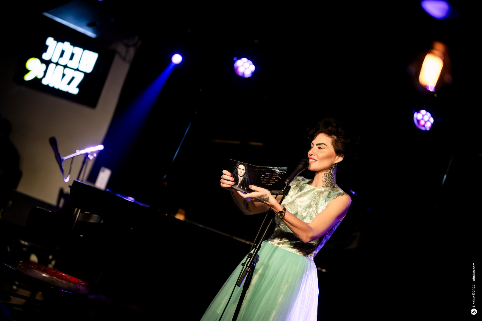 Kama Kamila singing on stage at jazz club