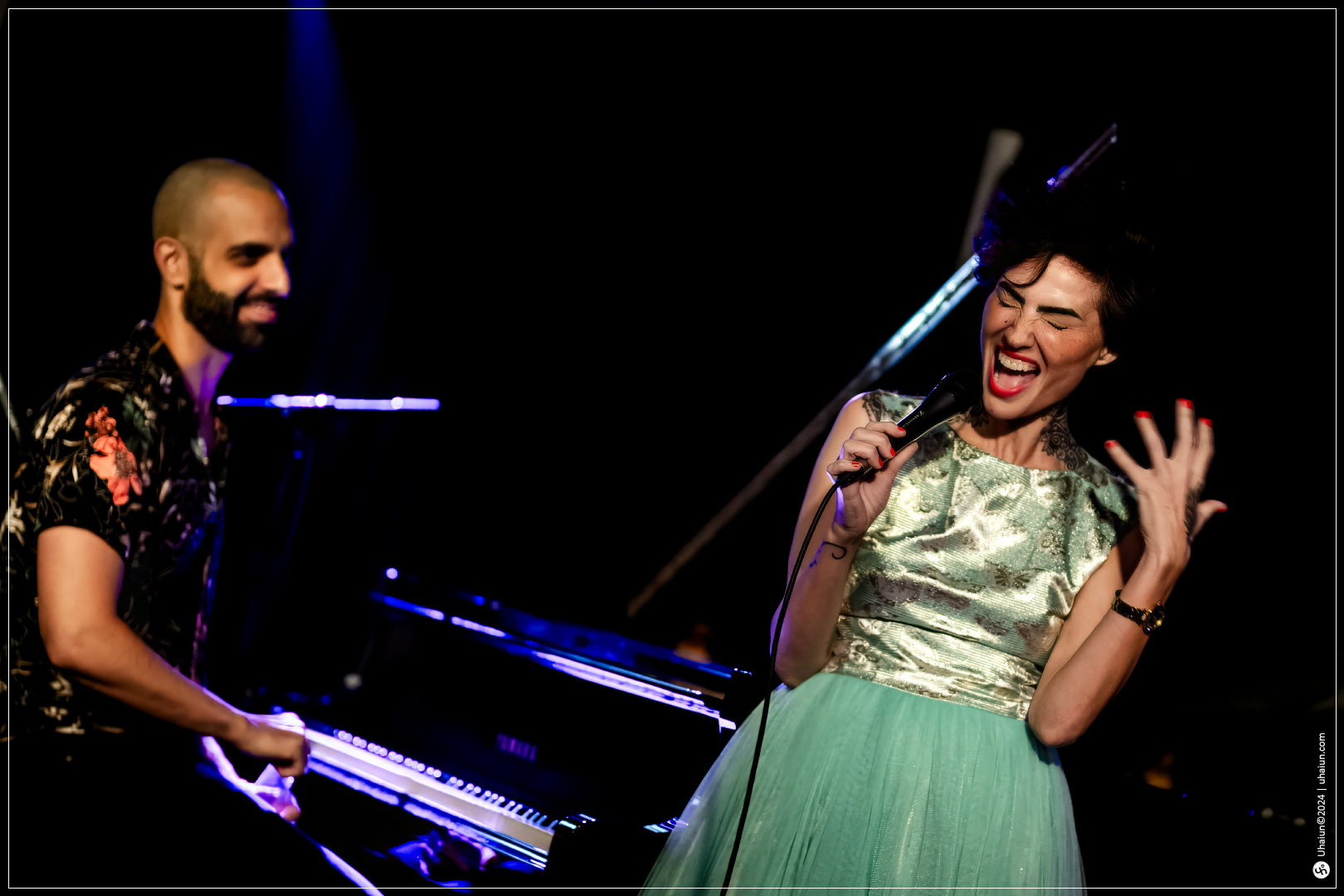 Kama Kamila performing on stage with pianist