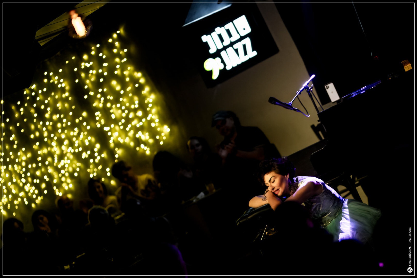 Kama Kamila performing live on stage with lights