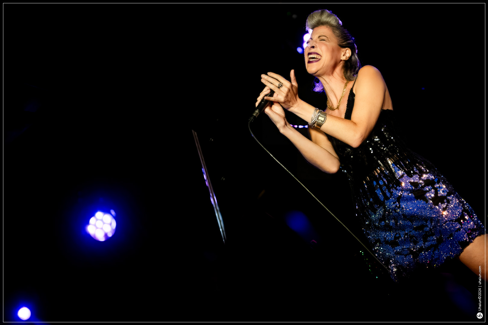 Michal Shapira singing energetically on stage