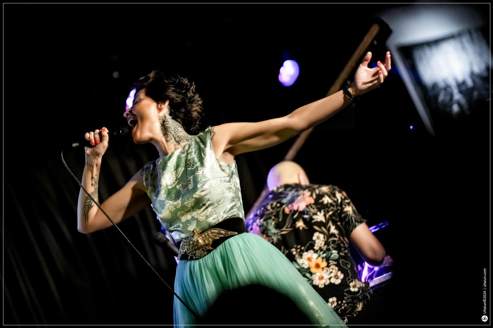 Kama Kamila singer performing enthusiastically on stage