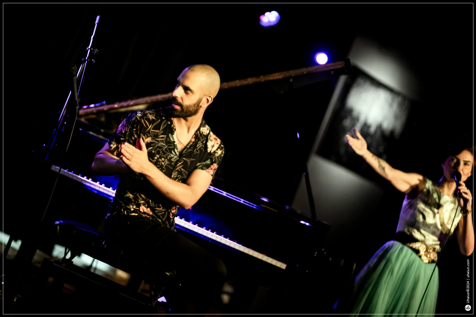 Musician playing piano and singer performing onstage