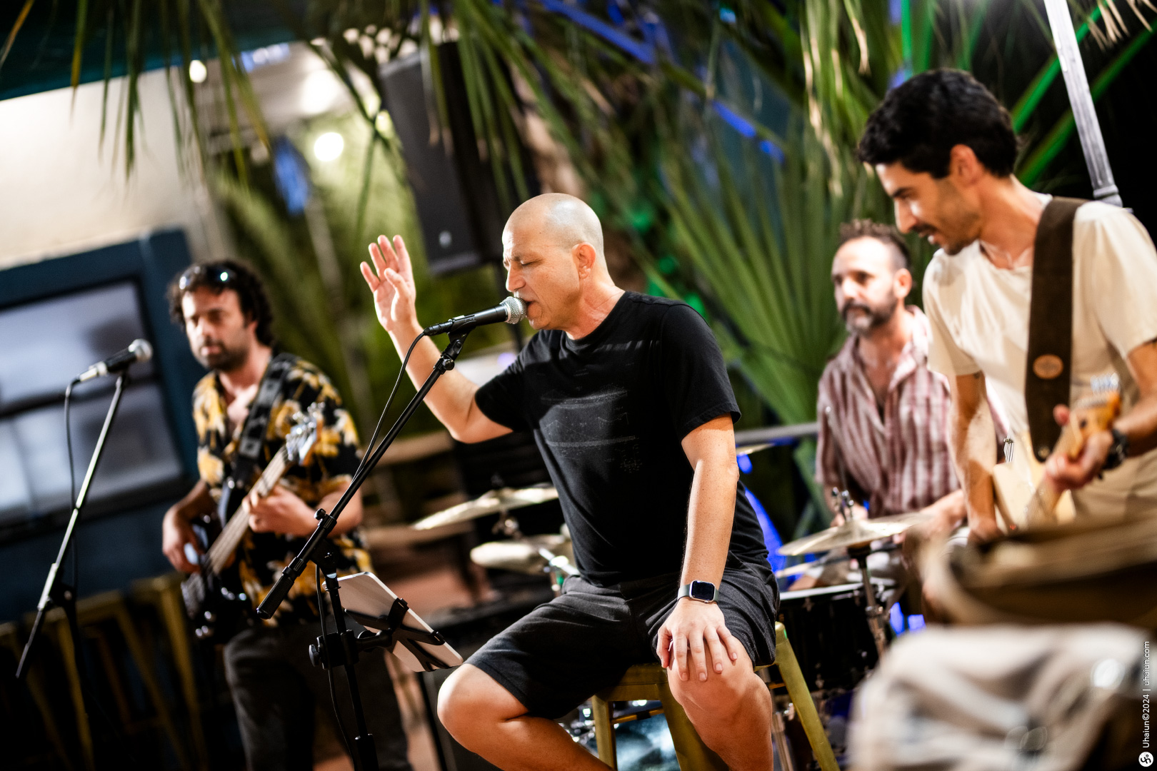 Live band performing at an outdoor evening event.