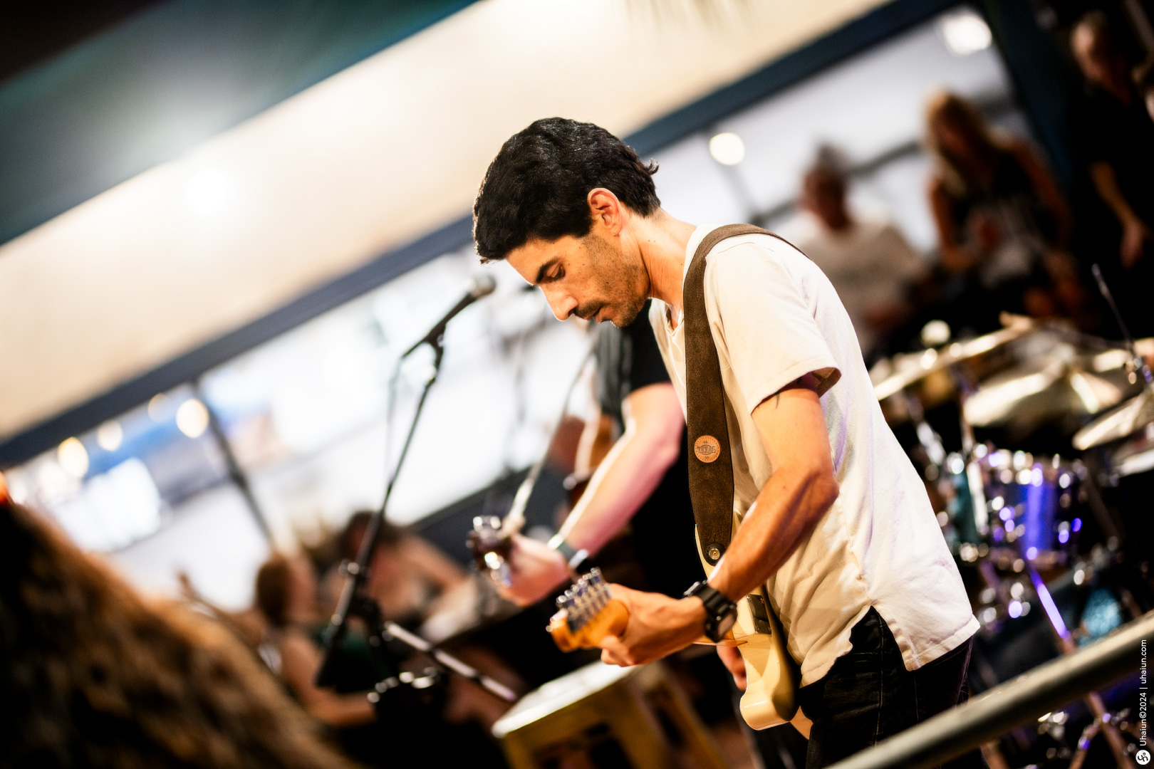 Guitarist performing live on stage at concert