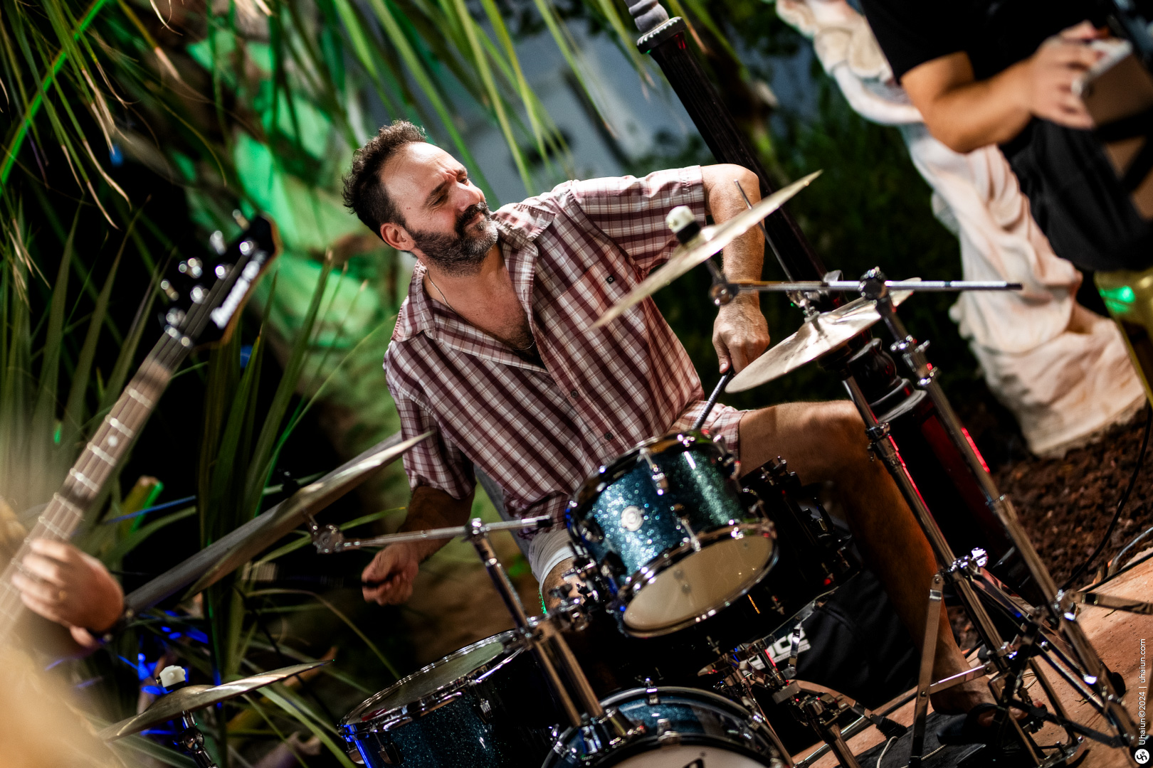 Drummer playing at a live outdoor music event.