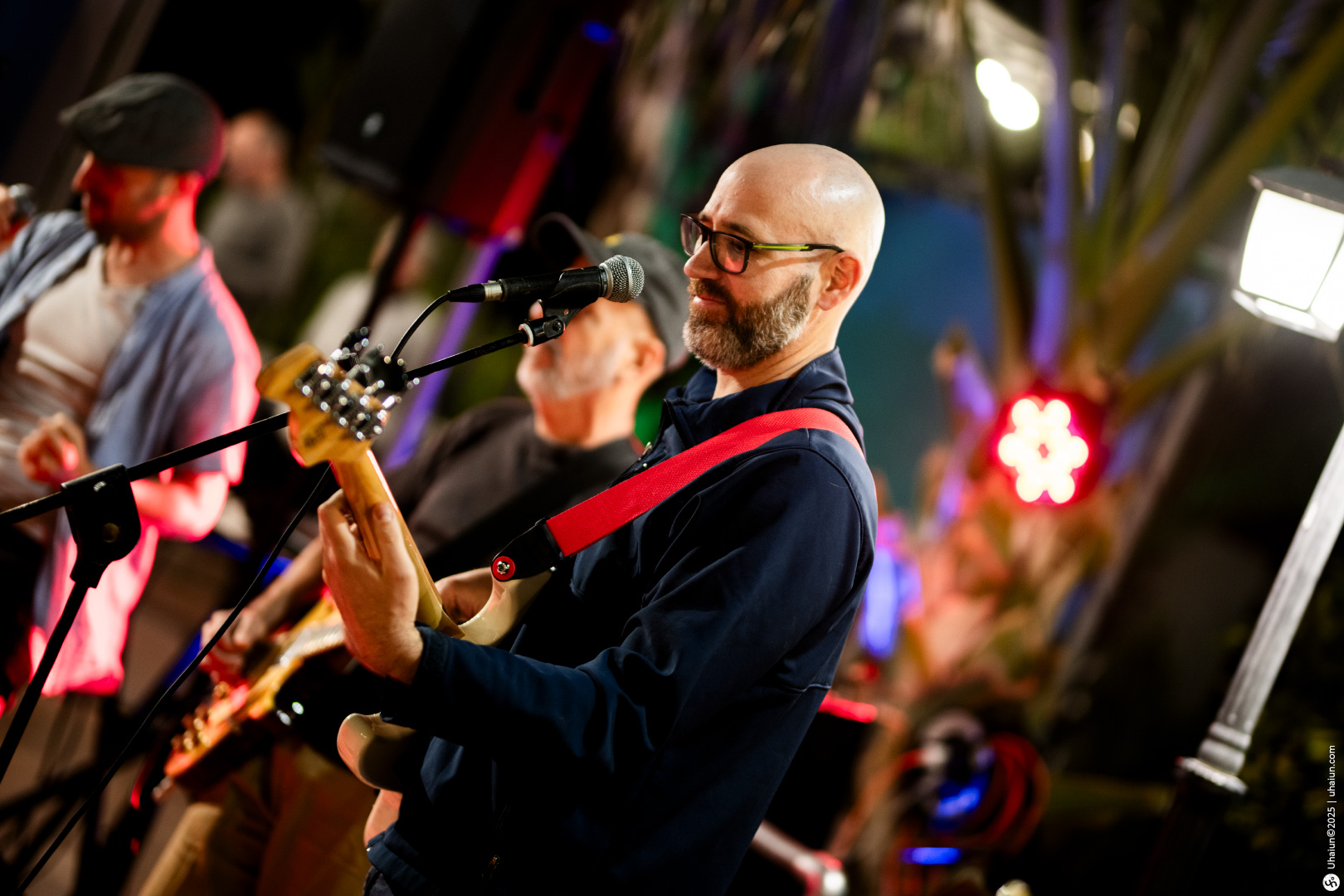 Musician performing with guitar at live event