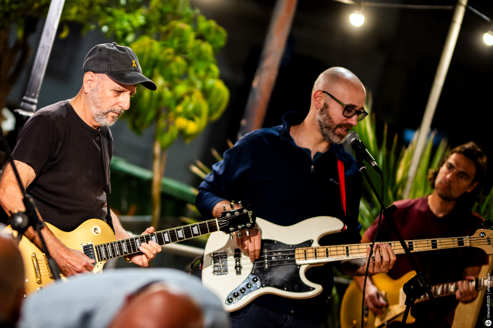 Live band performing outdoors at night concert