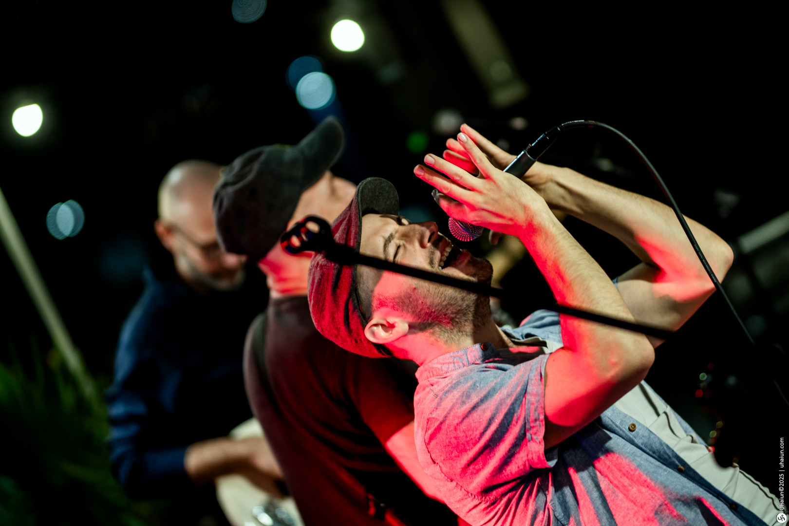 Musician passionately singing on stage with microphone