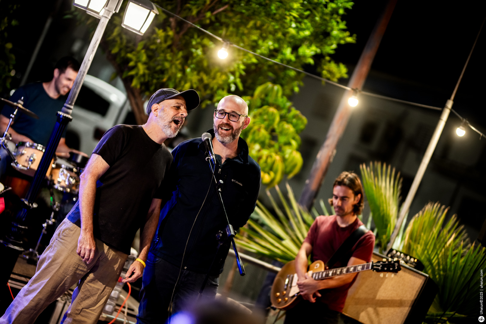 Outdoor music performance with two singers on stage
