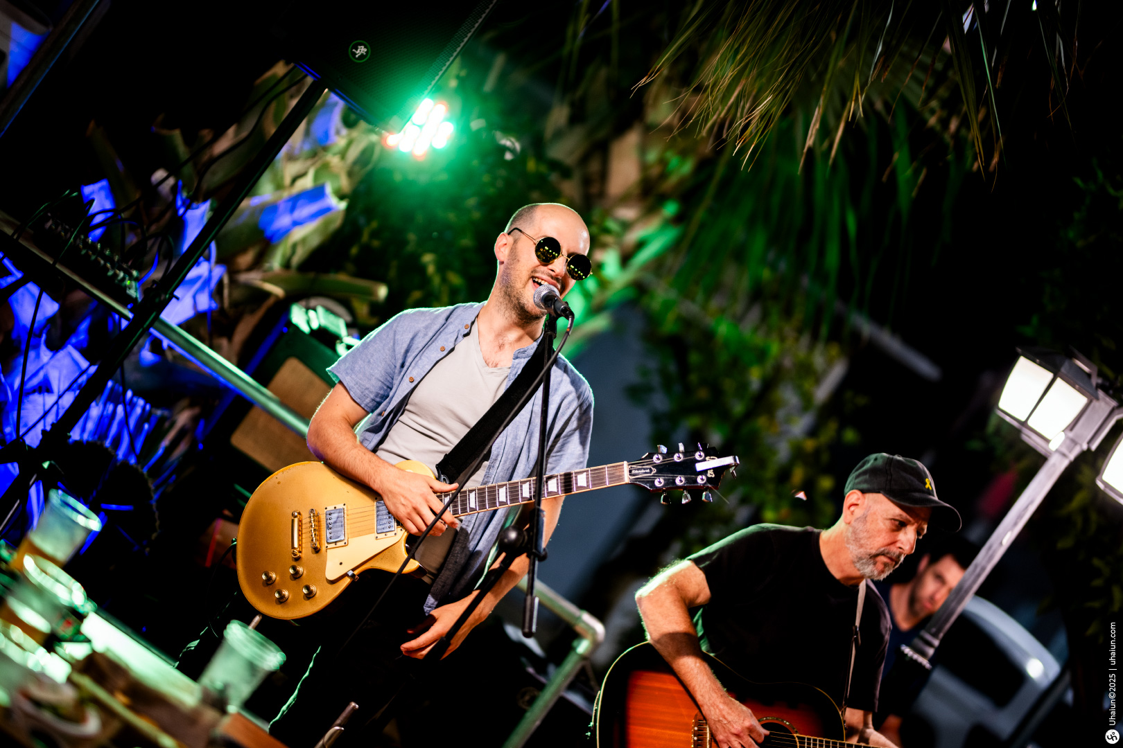 Musicians performing live with guitars on stage