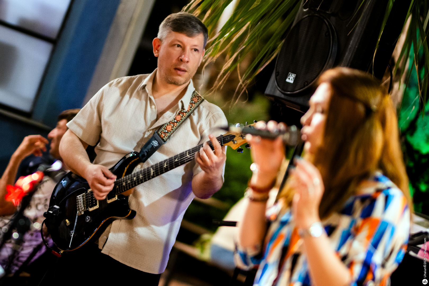 Man playing guitar at live music event