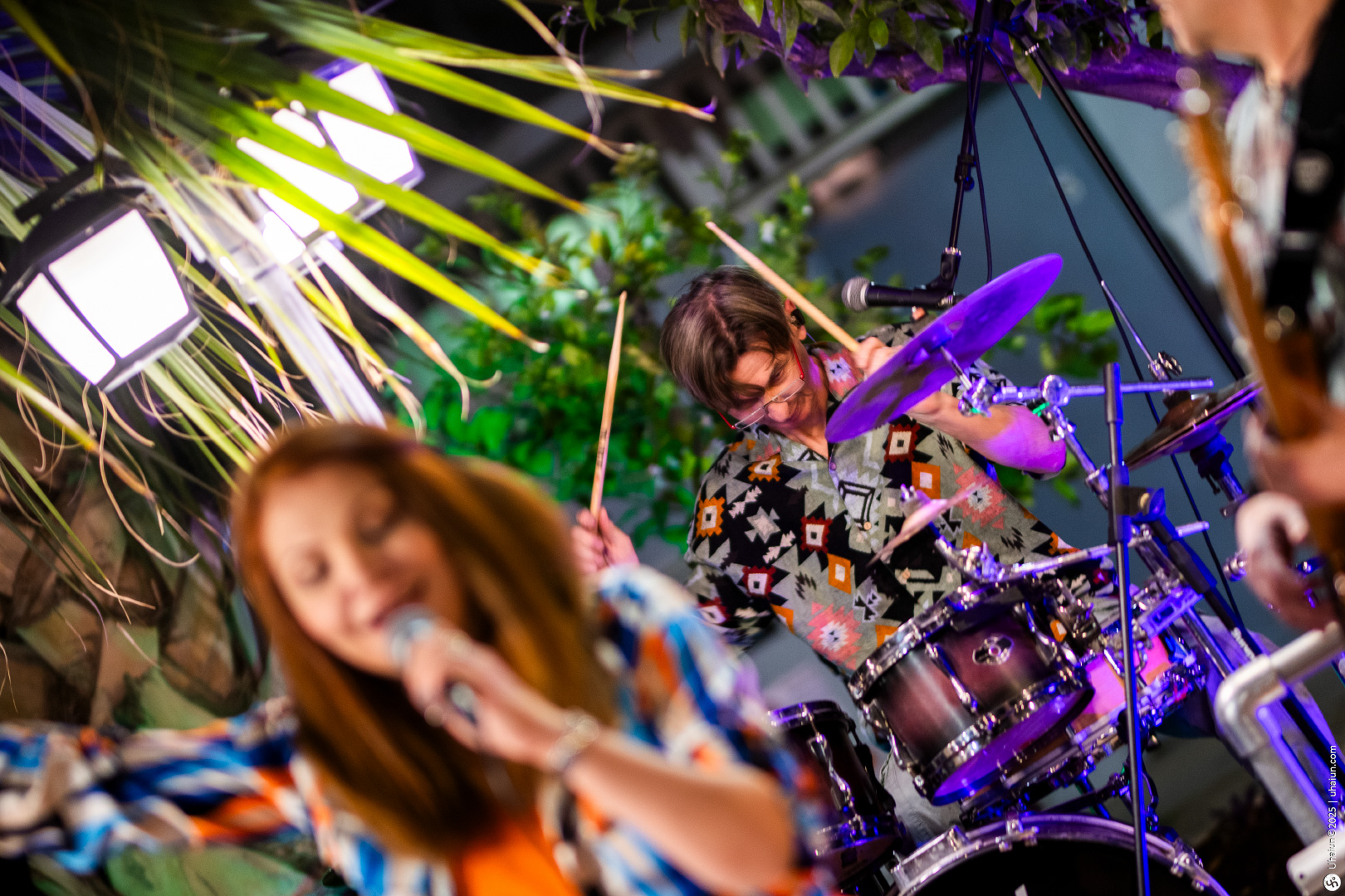 Blurred concert with drummer and singer performing