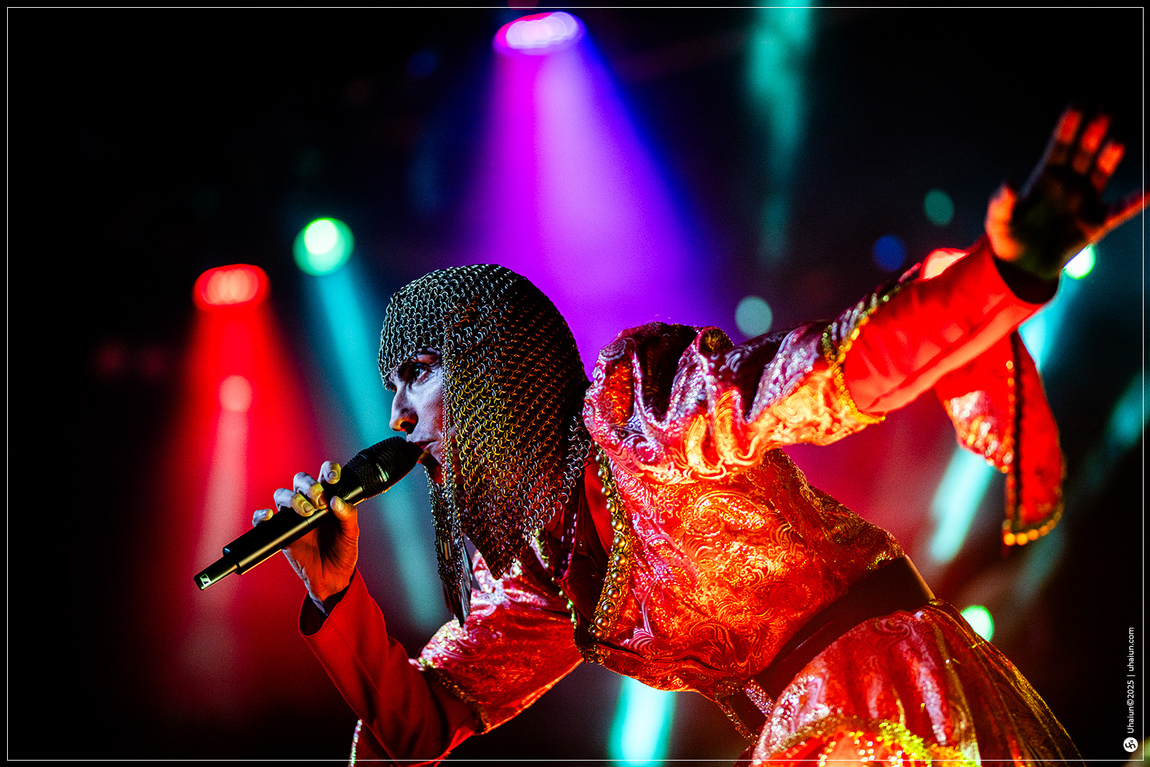 Performer in vibrant costume on colorful stage