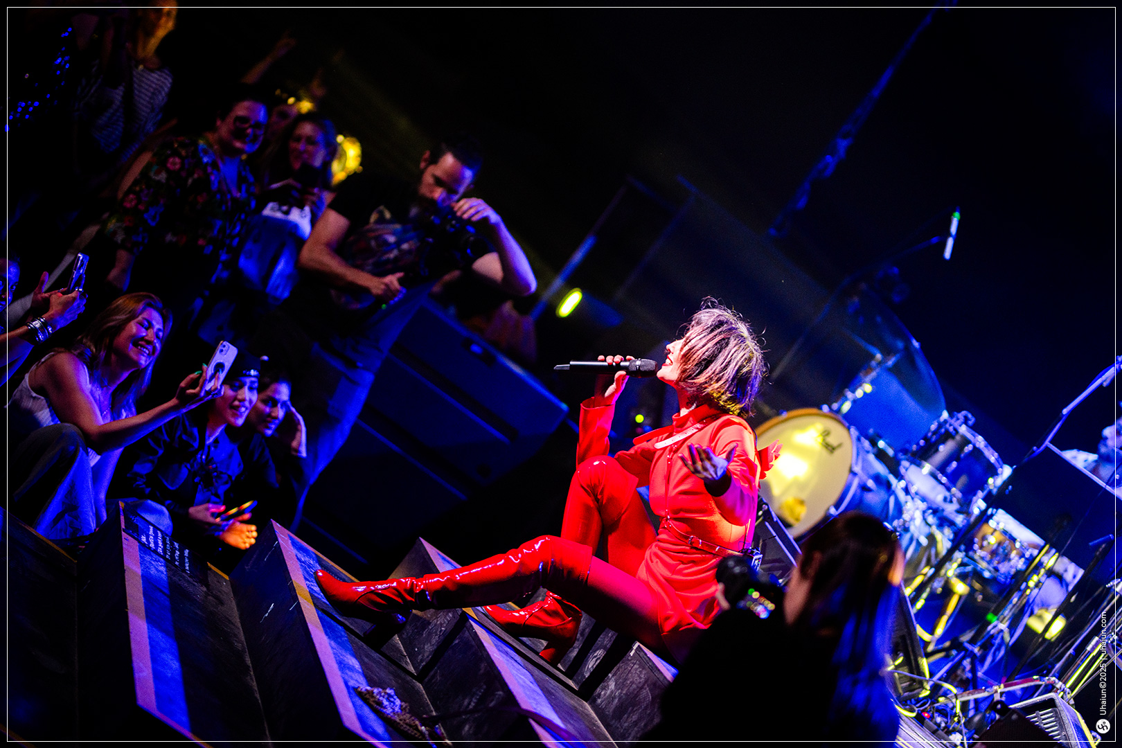 Singer performing on stage with excited audience