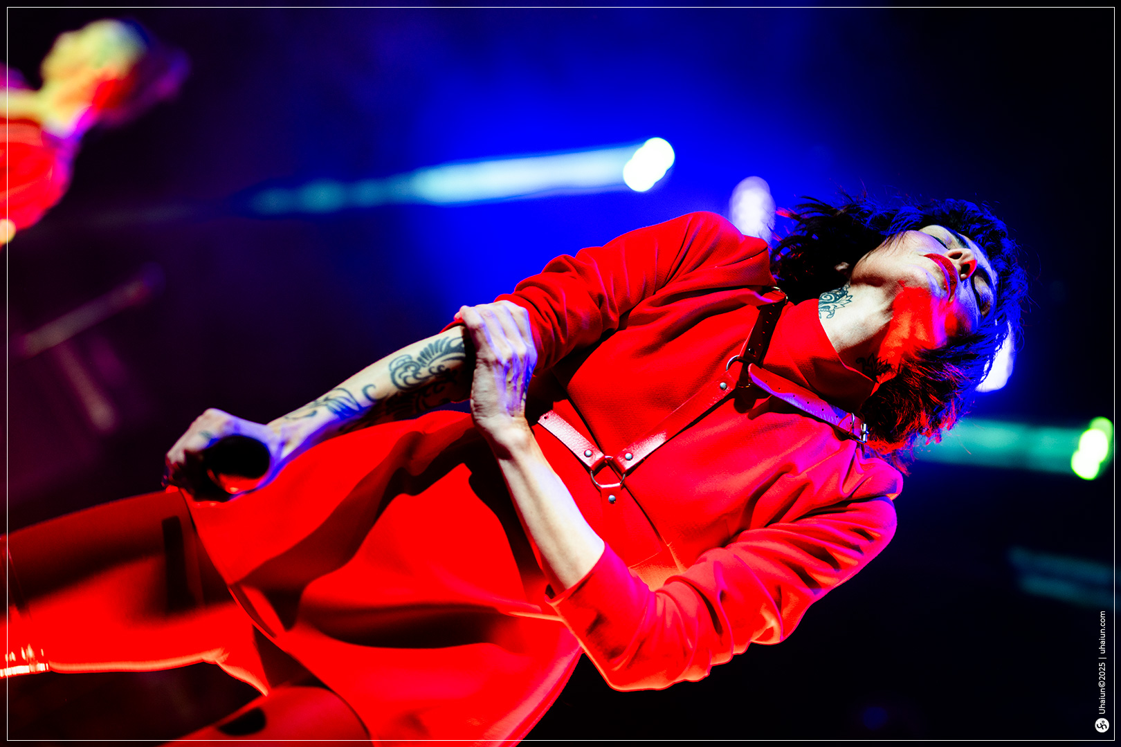 Performer in vibrant red outfit on stage