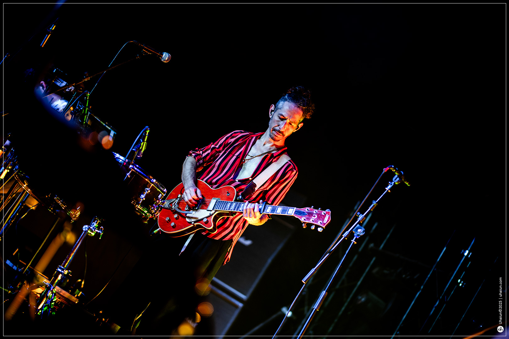 Musician performing live with electric guitar onstage
