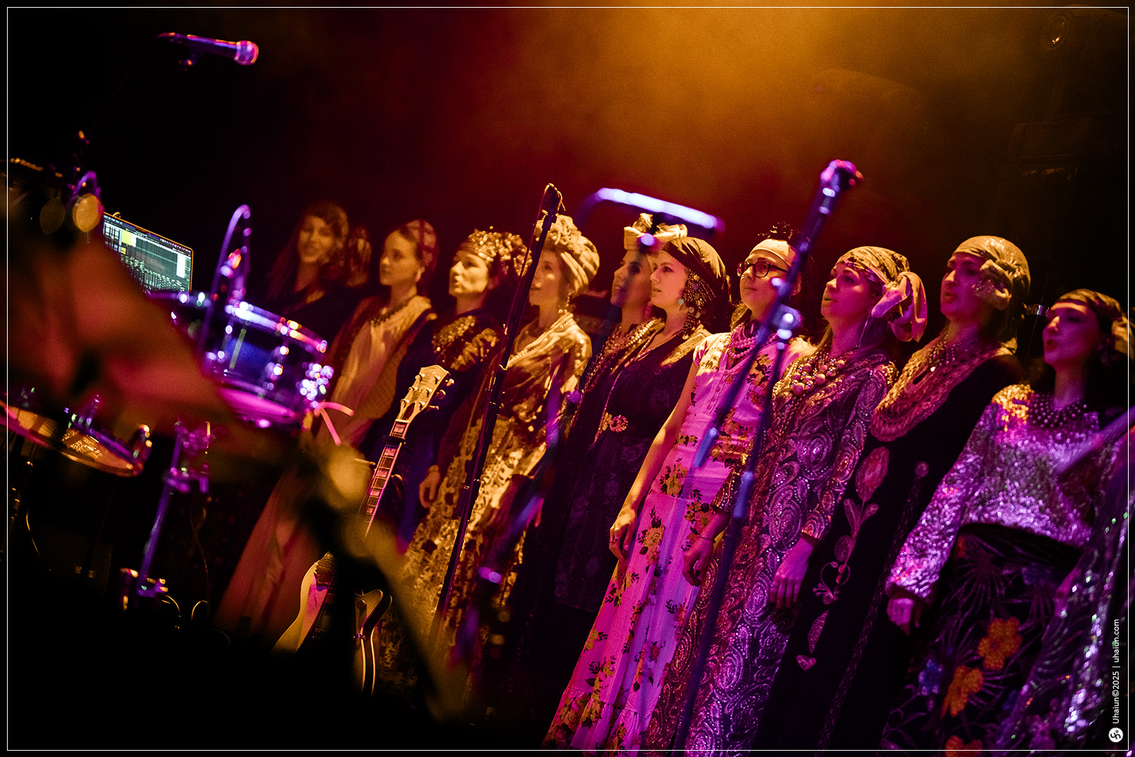 Performers on stage in colorful traditional attire