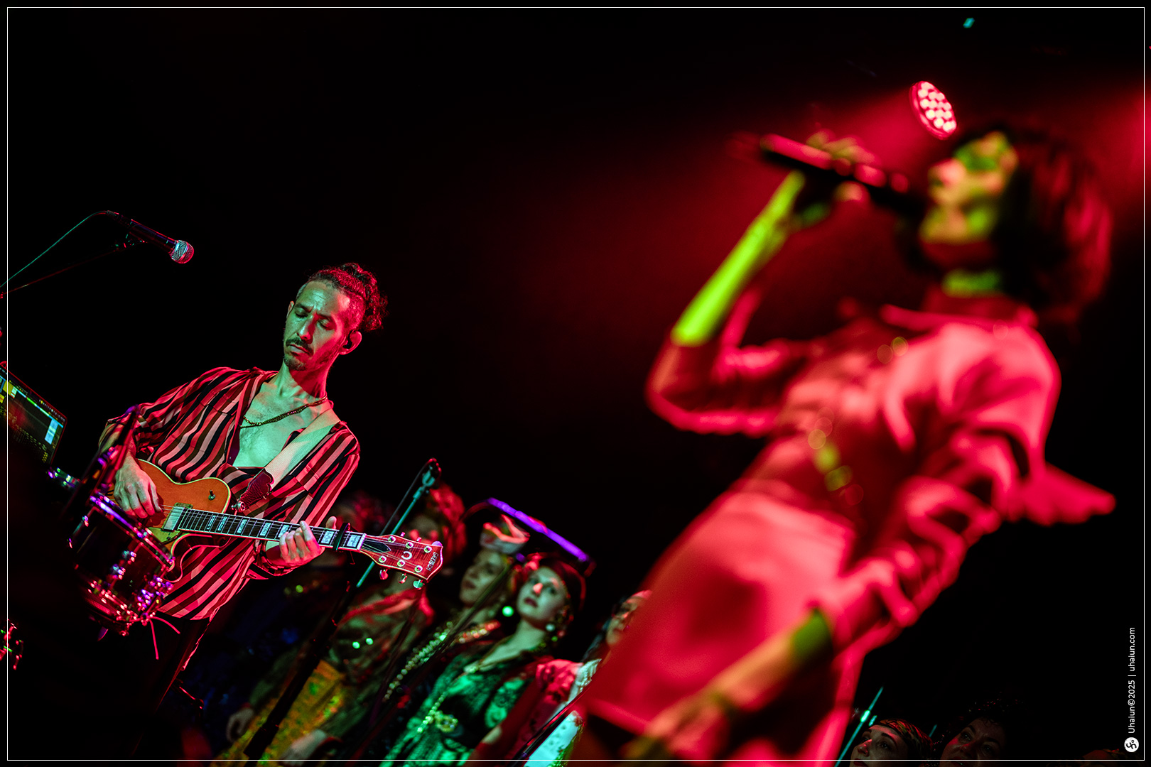 Musicians performing live on stage with lights