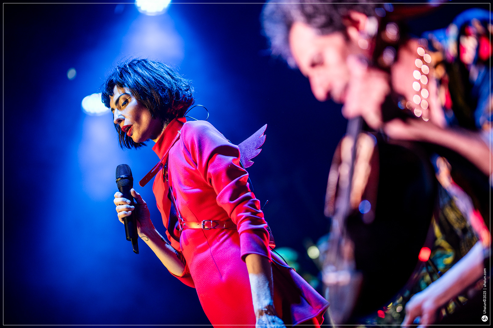 Musician performing on stage with bright lights