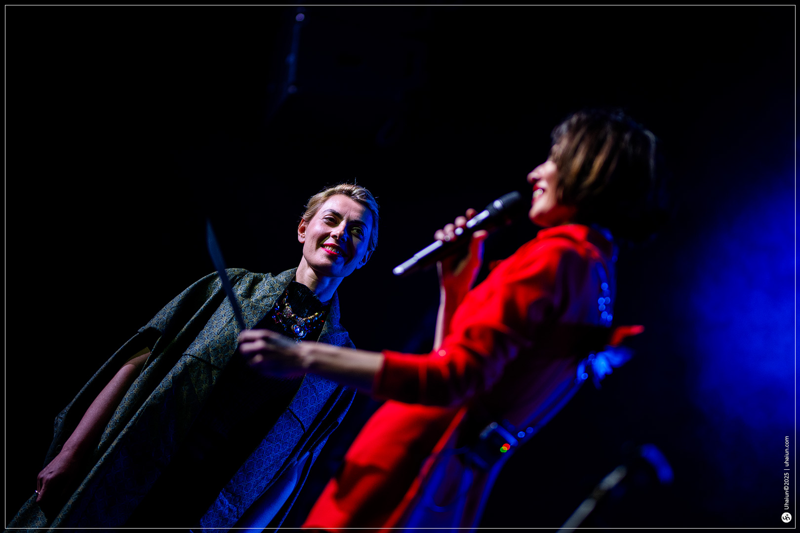 Two women speaking on a stage event