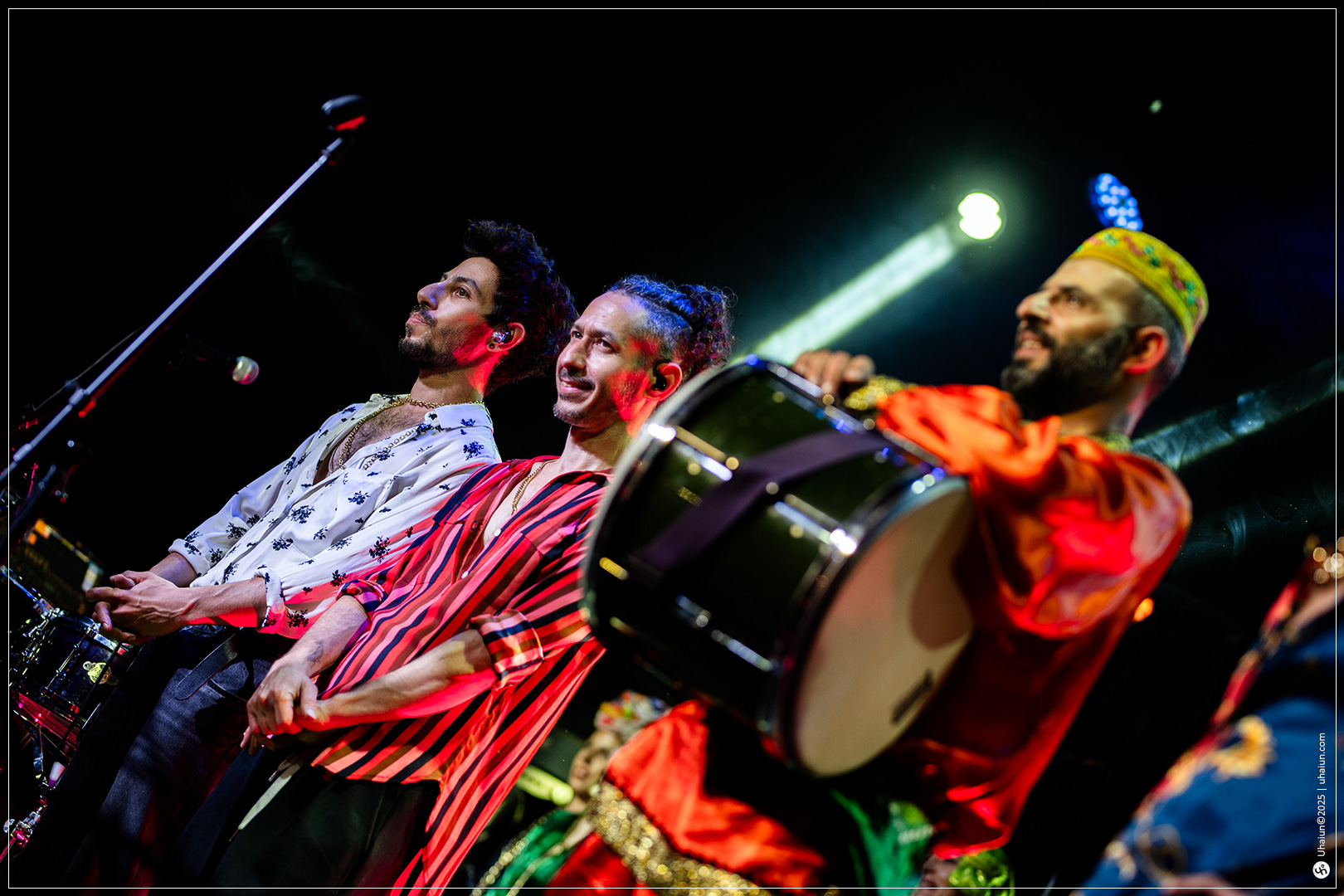 Musicians performing vibrantly with drums on stage