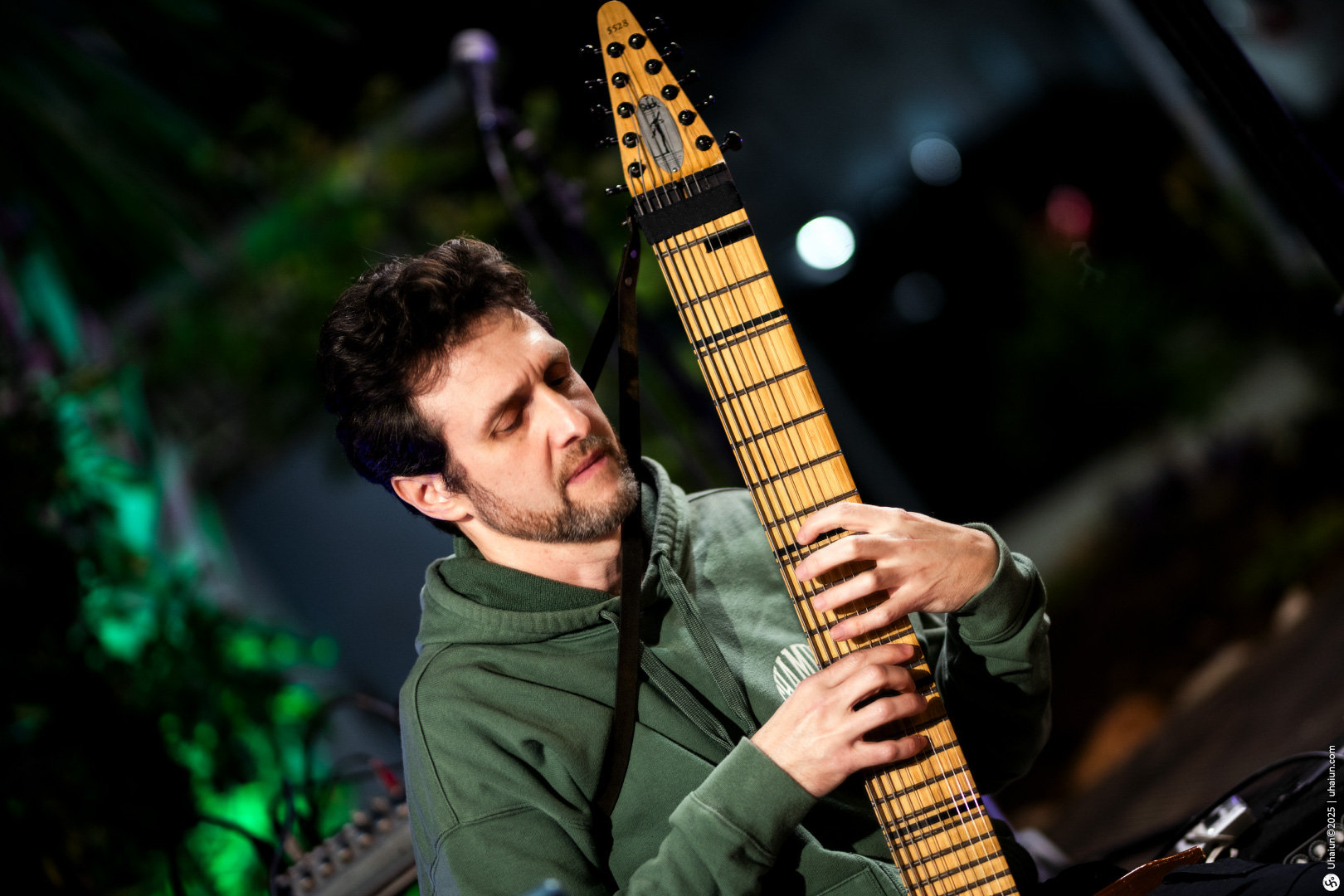 Musician playing an unusual stringed instrument outdoors
