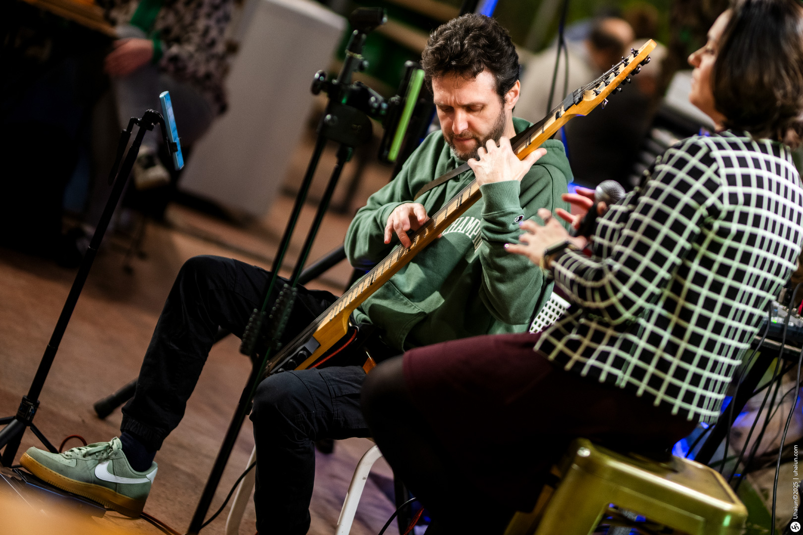 Musician playing guitar during live performance session
