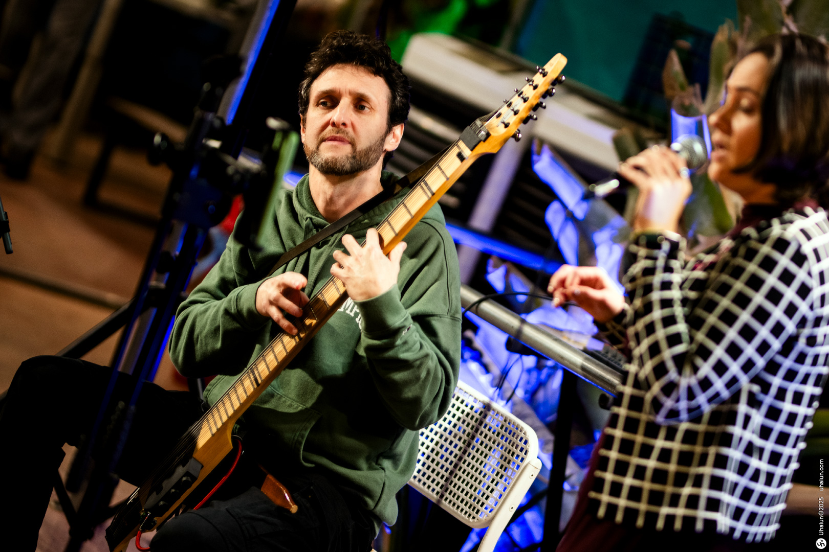 Musicians performing live with guitar and microphone