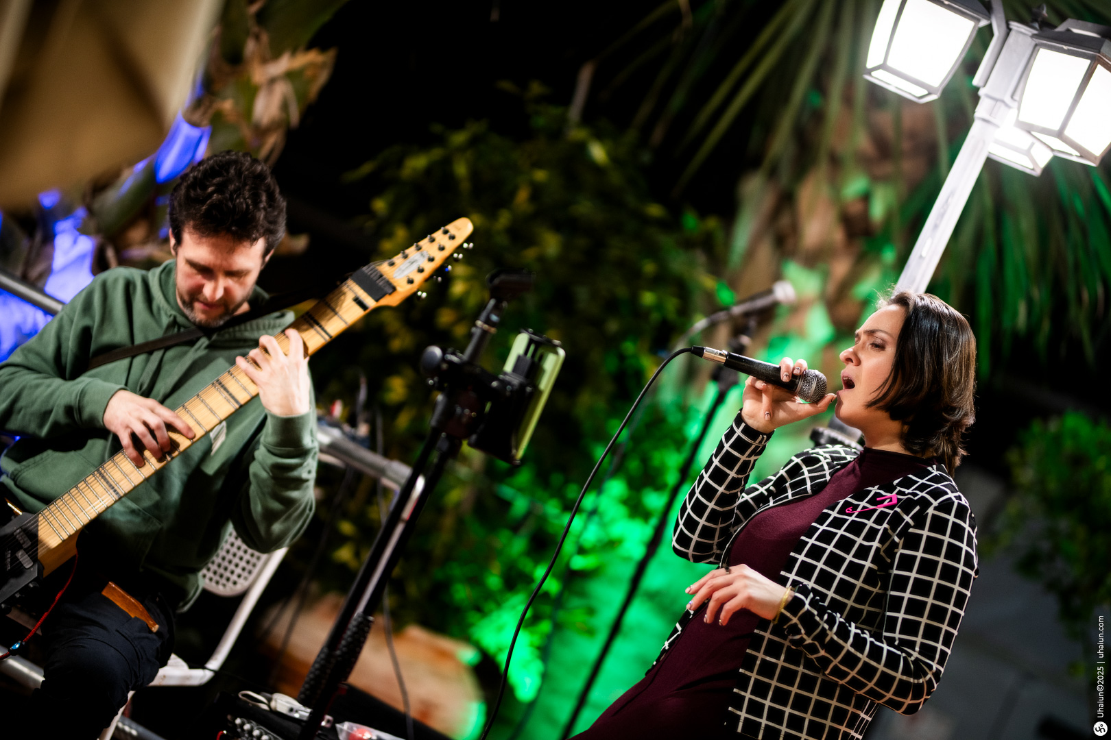 Musician and singer performing outdoors at night