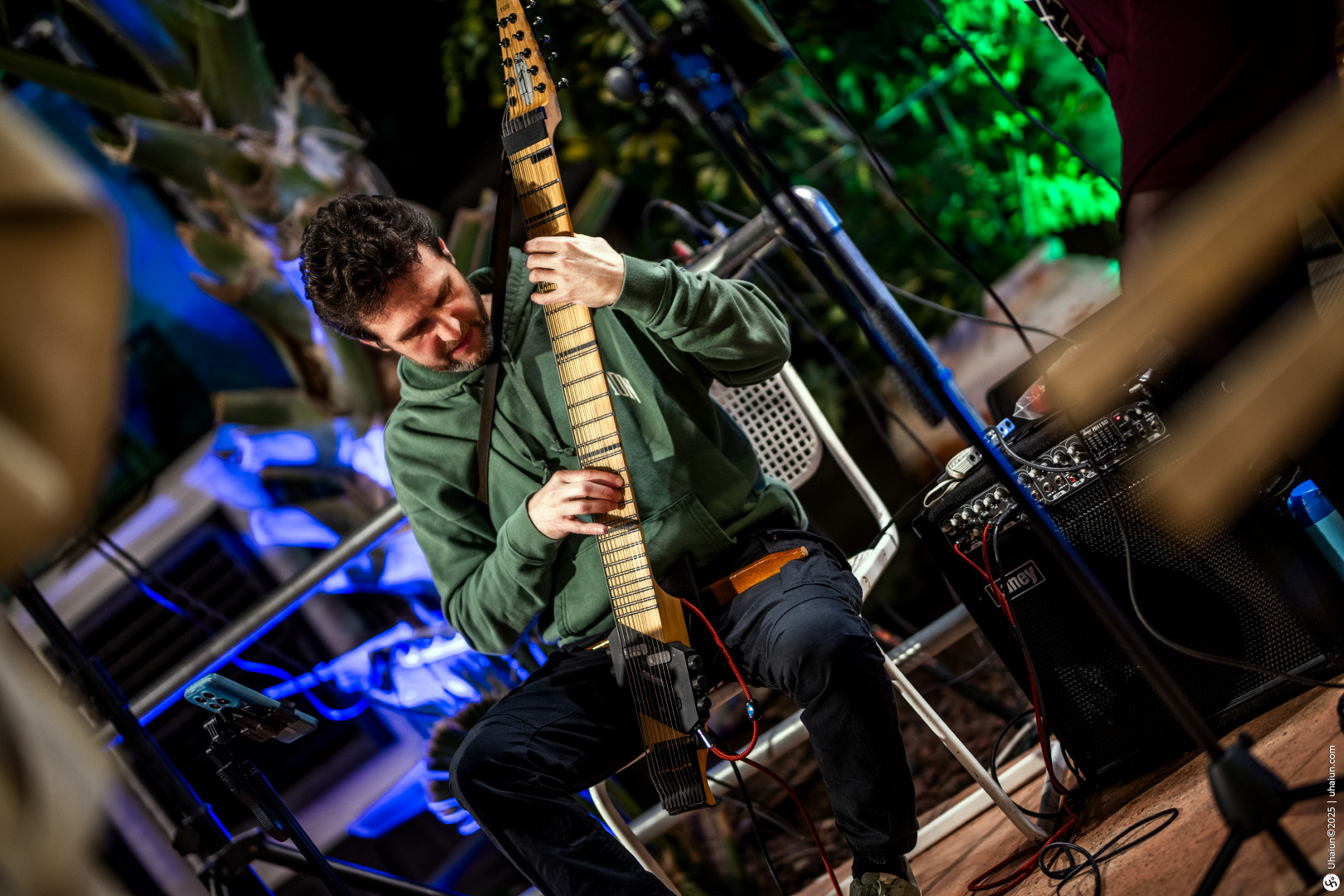 Musician playing electric guitar at outdoor event